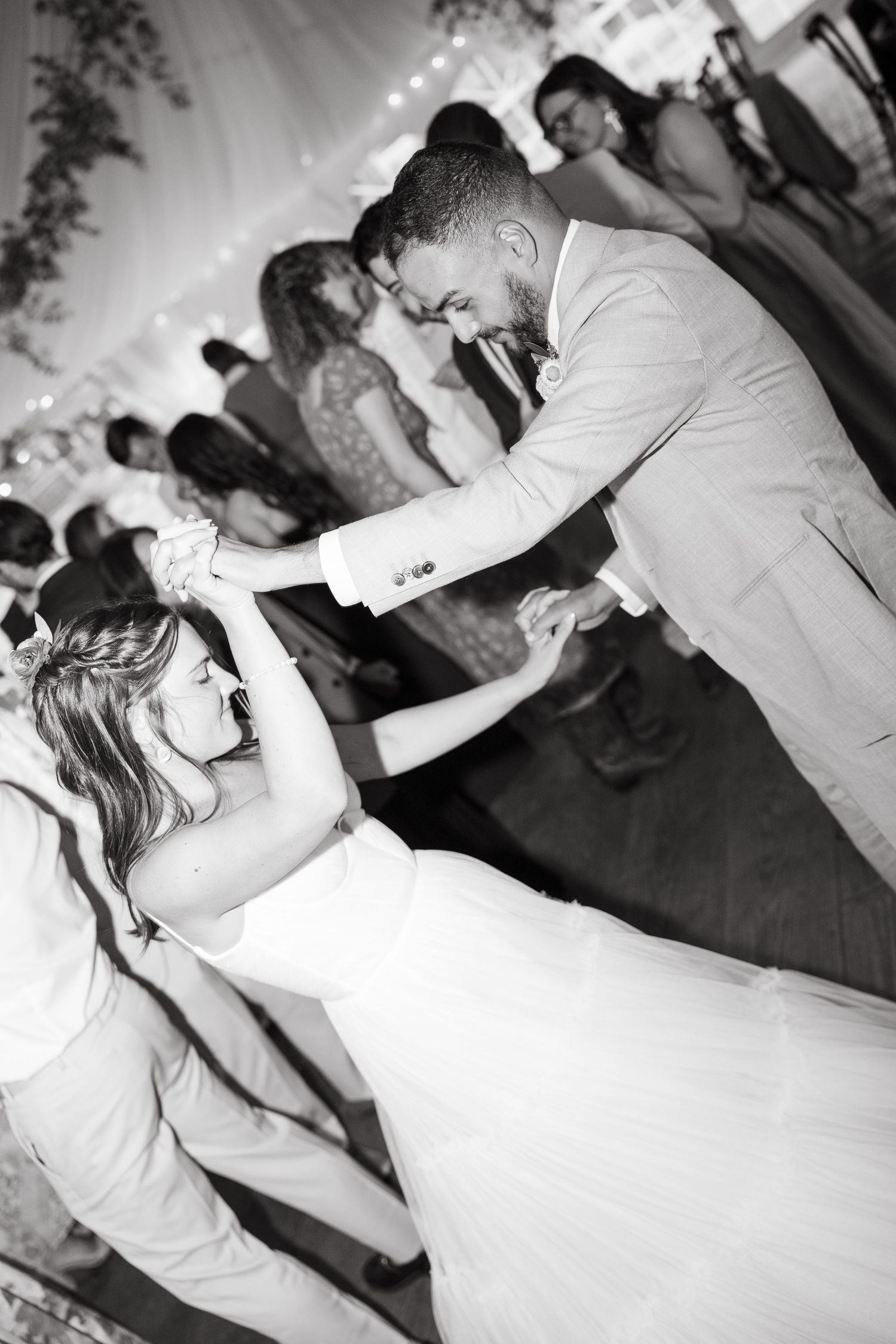 Black and white photos of couples dancing at an evening wedding reception.