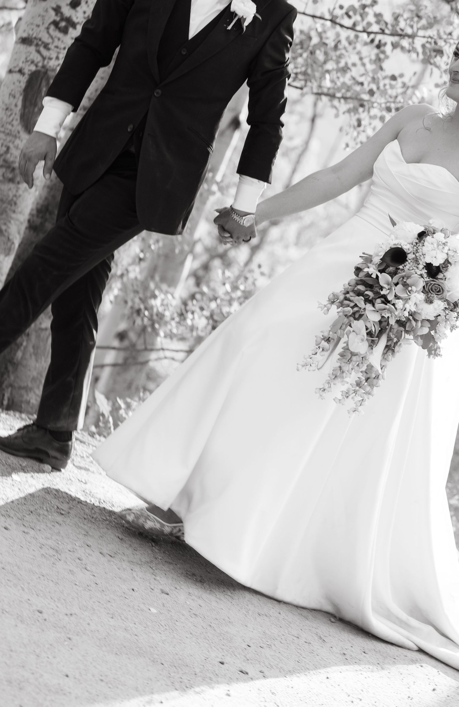 Black and white wedding photo series showing close-up details of bride and groom's feet during outdoor ceremony.