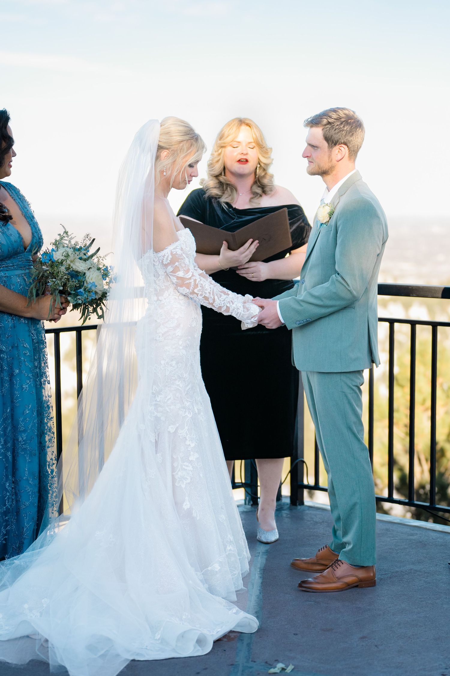bride and groom getting married holding hands during ceremony