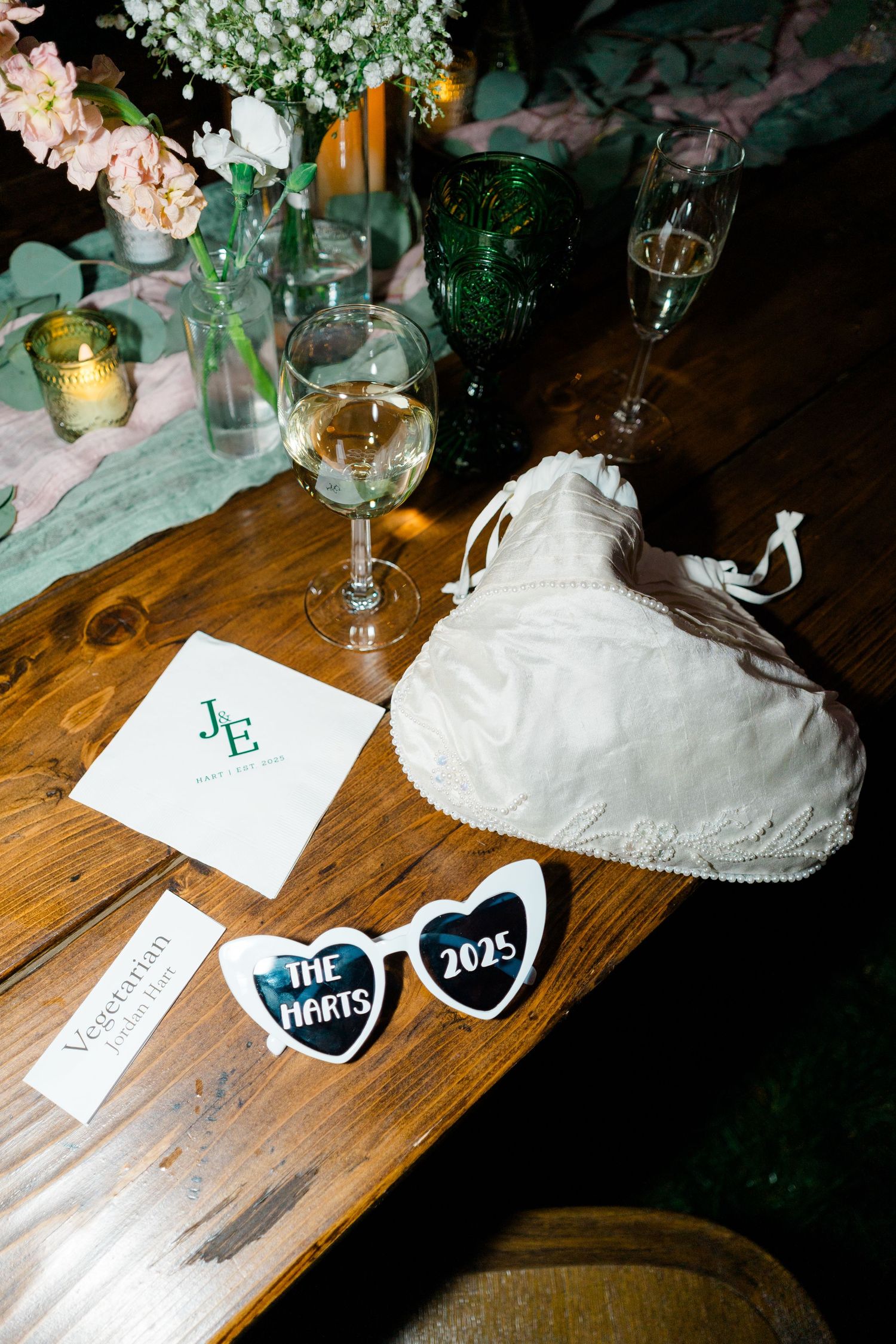 Wedding reception table decor with floral arrangements and photo booth props displaying during vail wedding.