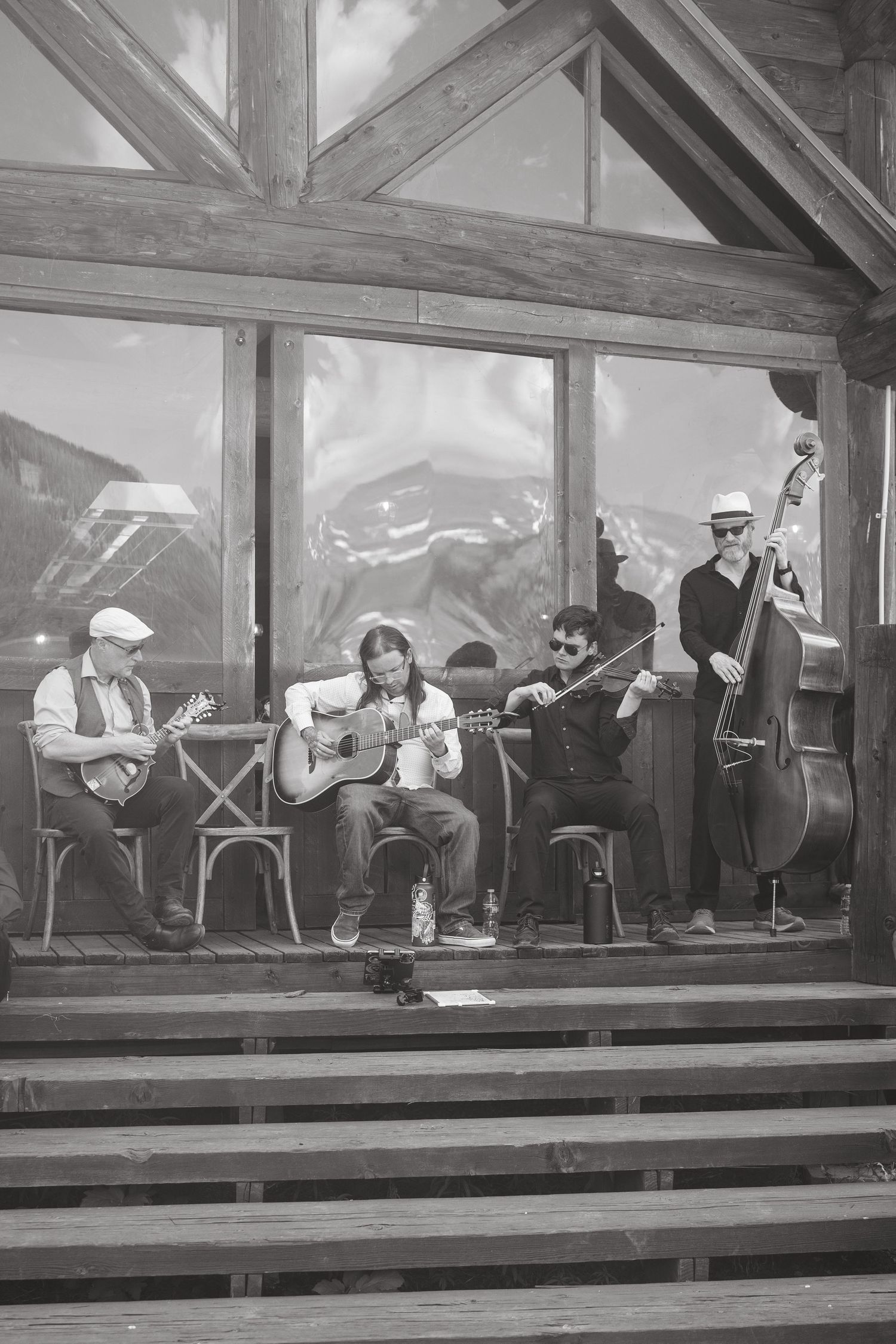Black and white photo of musicians performing in a row on stage.