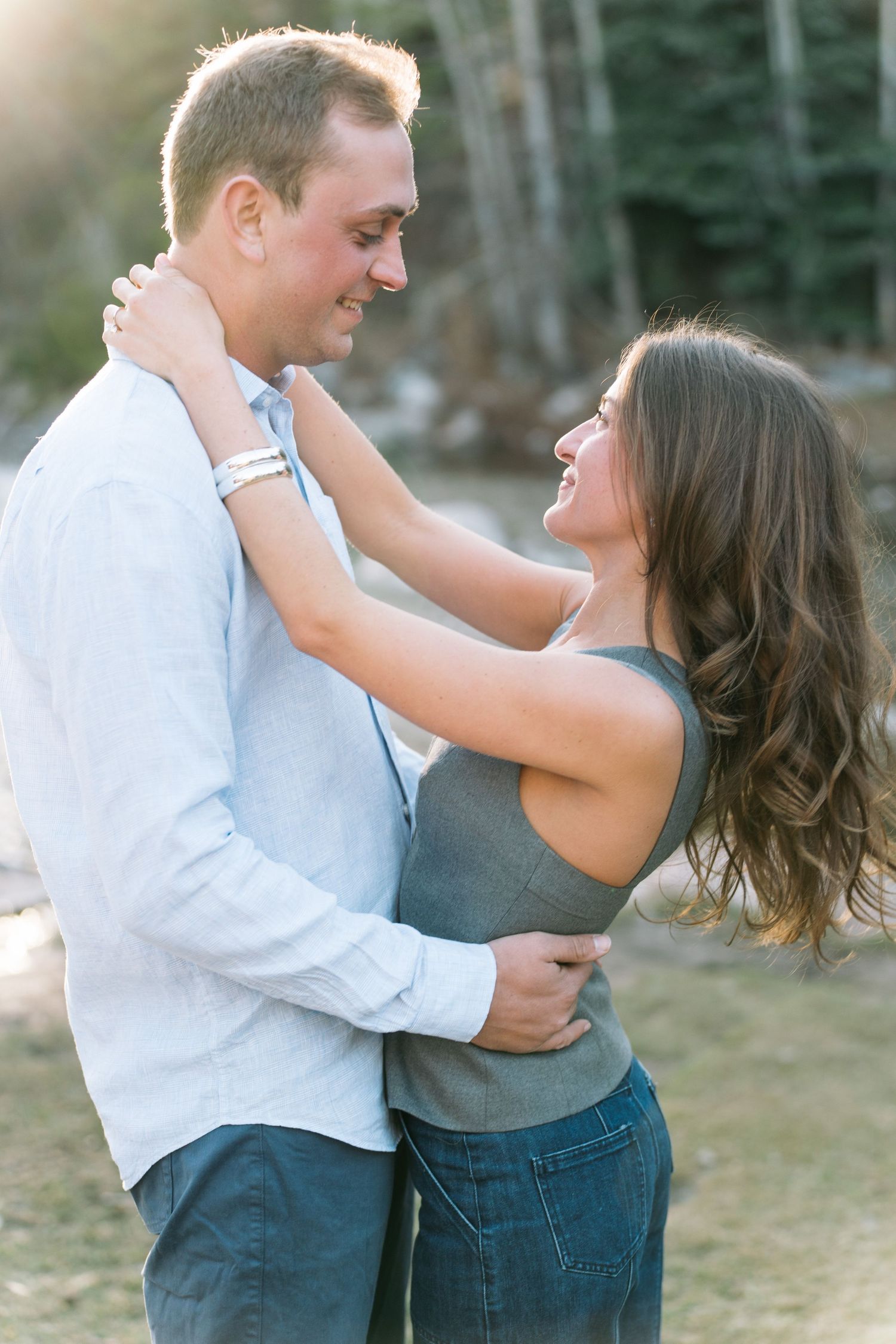 A couple shares a romantic moment outdoors, embracing and smiling at each other in a series of candid shots.
