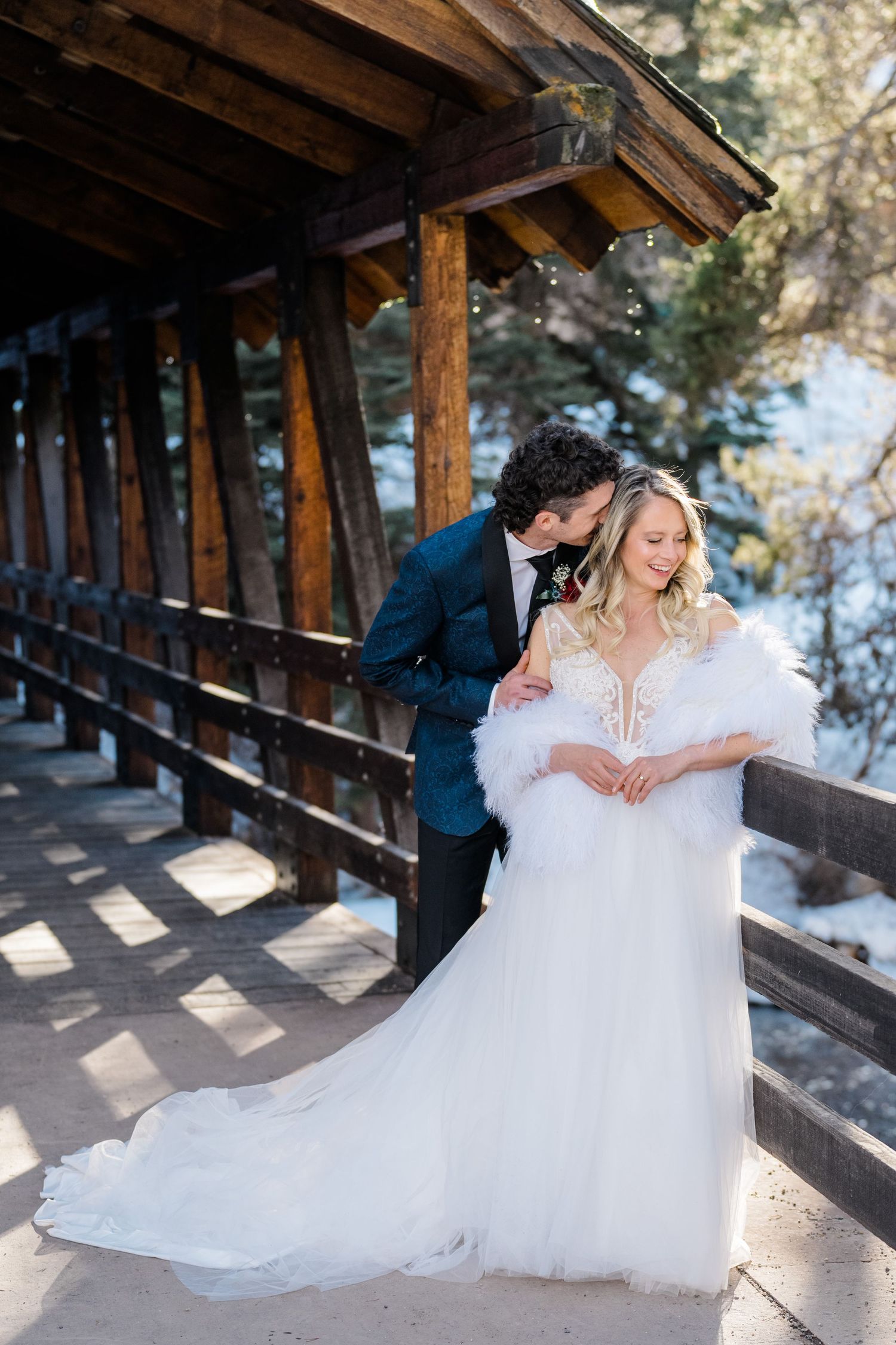 bride and groom on bridge looking at each other