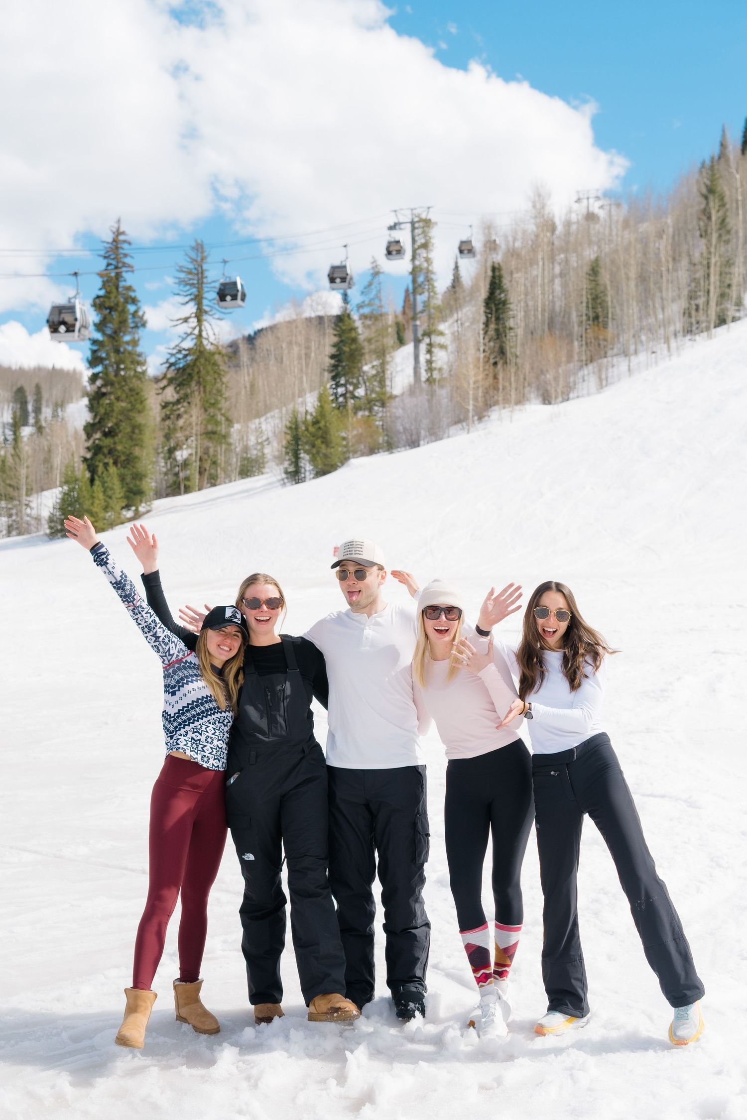 friends on the ski mountain after a guy and girl got engaged and they are all celebrating