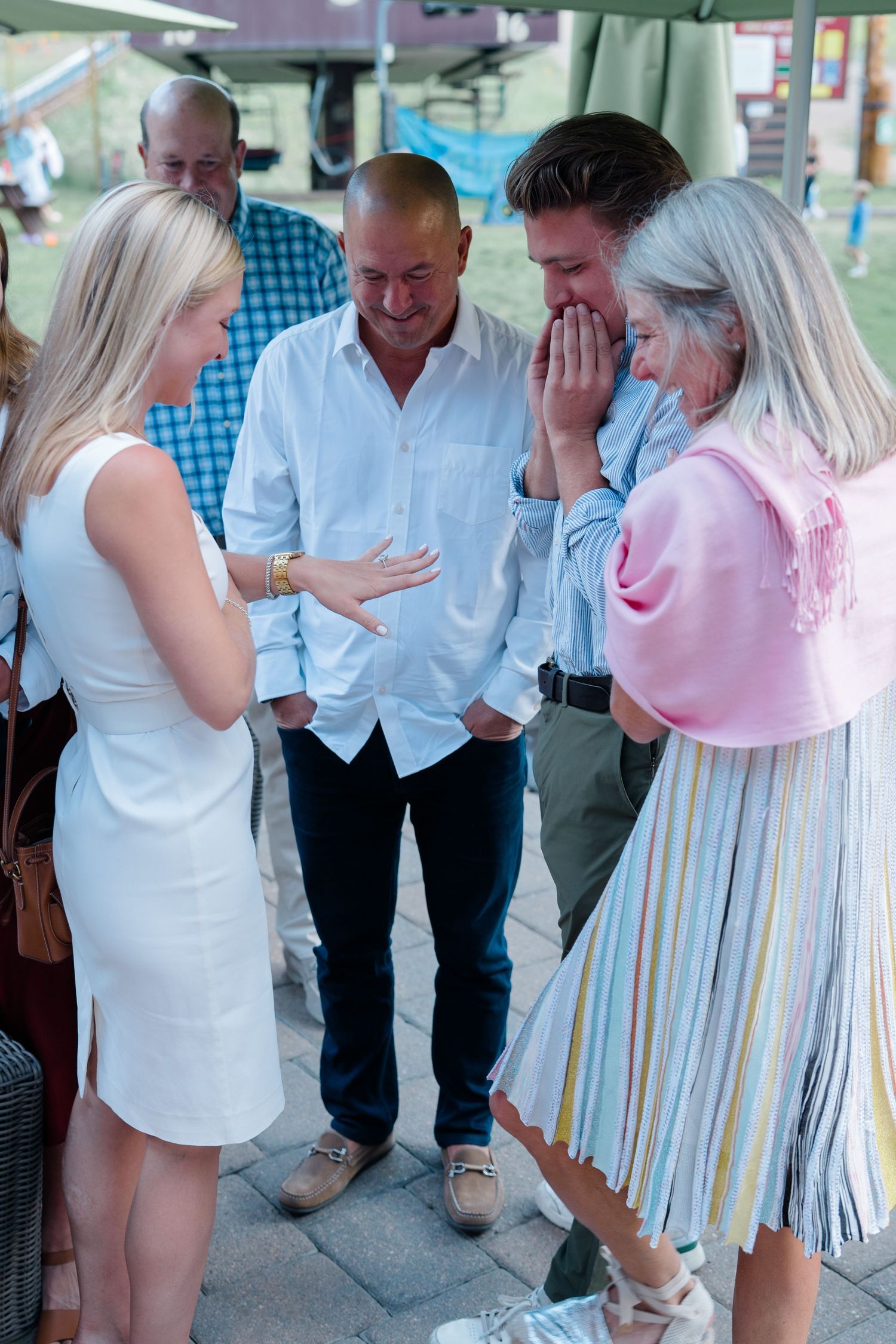 family excited looking at girls ring