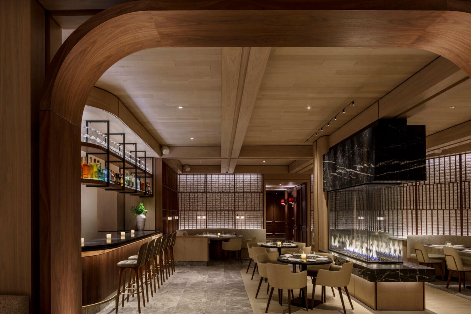 Chasing Rabbits Vail Wedding Venue - Elegant restaurant interior with warm wood arches, bar seating.
