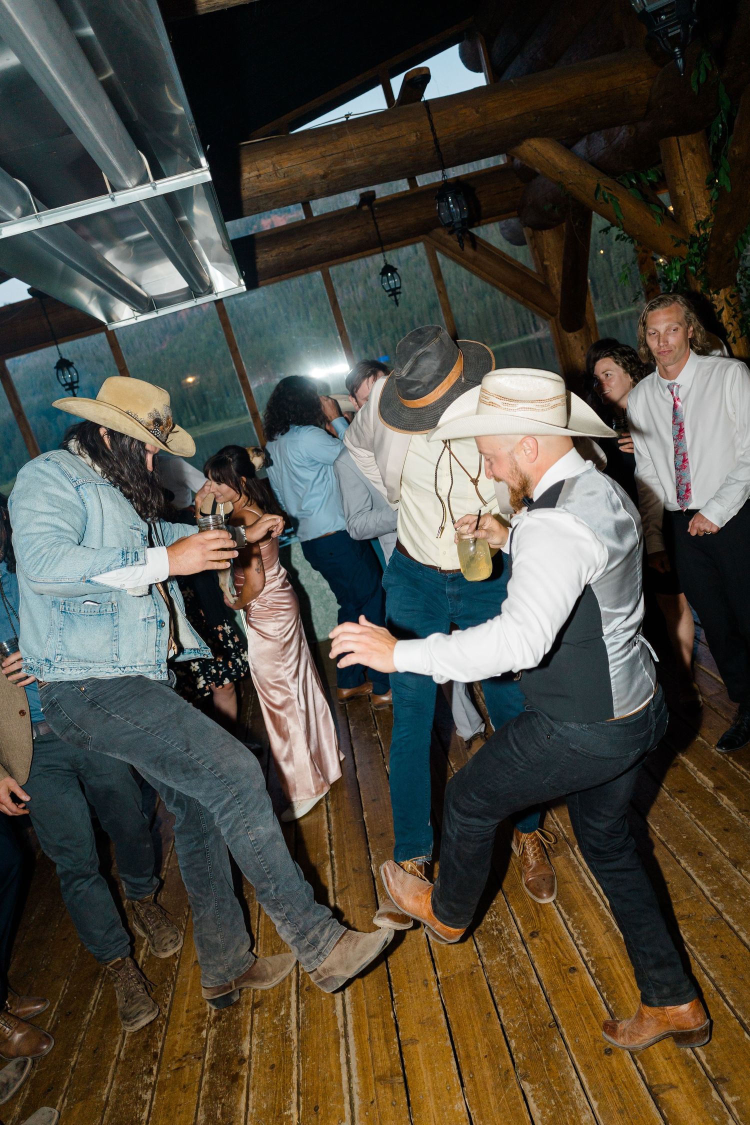 A sequence of dance moves showing people performing energetic swing dance steps on a wooden floor at Piney River Ranch.