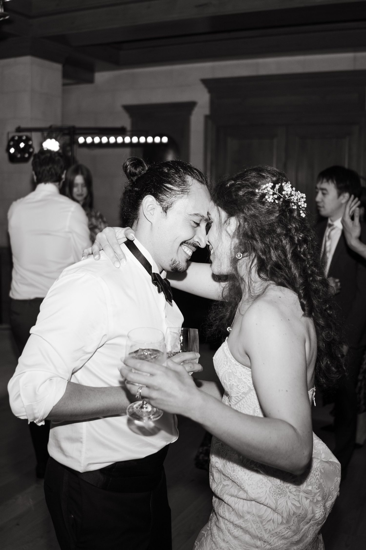 A sequence of black and white photos showing couples dancing and embracing at what appears to be a wedding reception.