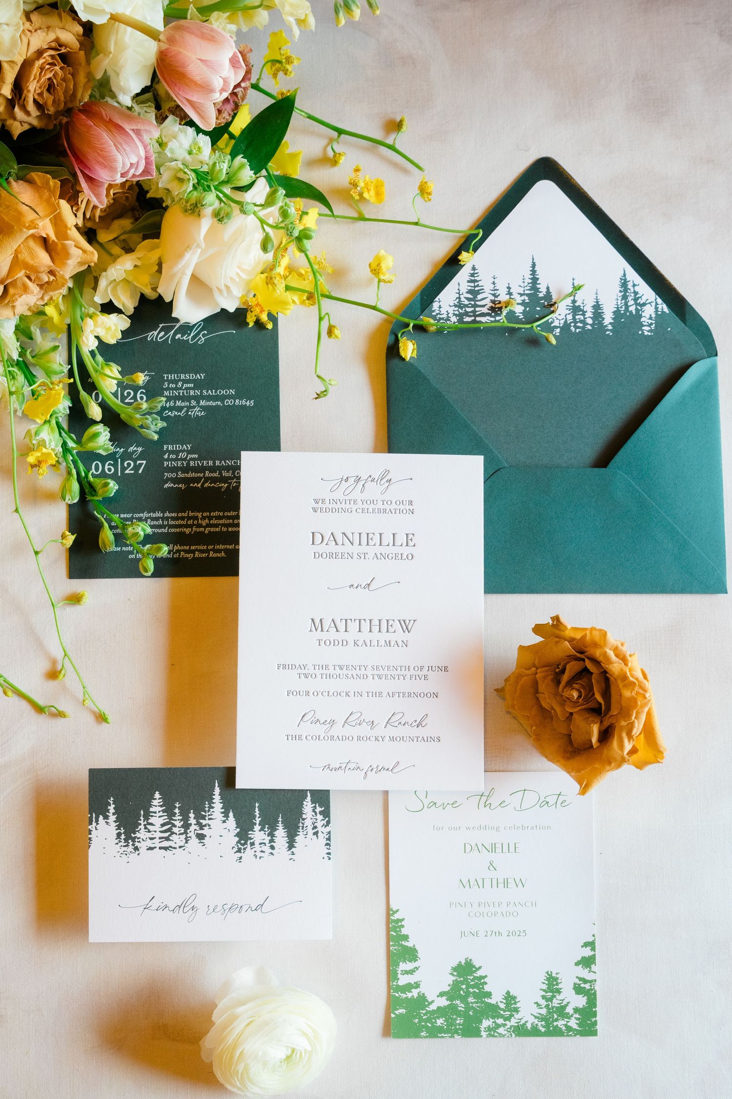 Forest-themed wedding invitation suite in emerald green and white with floral accents.