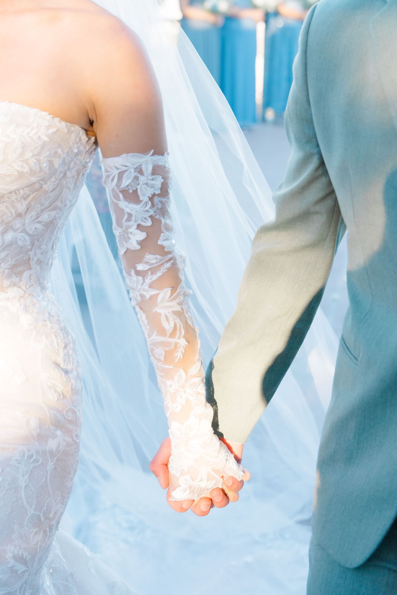 husband and wife holding hands in the light