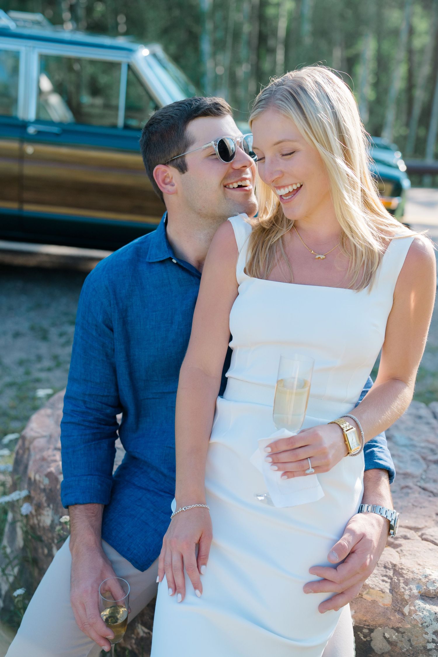 guy and girl celebrating after engagement with champagne