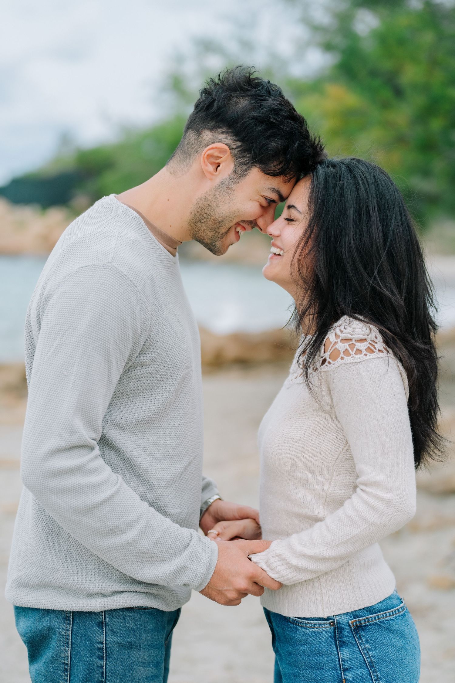 Romantic couple in casual outfits sharing tender moments in a series of intimate outdoor photos by the water.