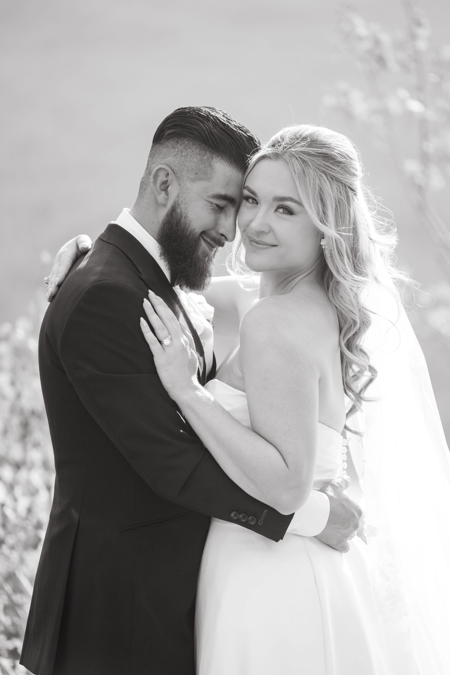 A romantic black and white photo series showing tender moments between newlyweds in an outdoor setting during Breckenridge micro wedding.