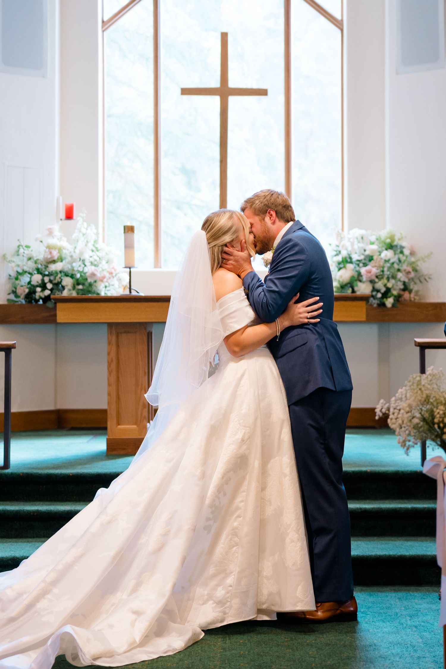 A romantic wedding sequence showing multiple dips and kisses between a couple in a church setting with floral decorations.