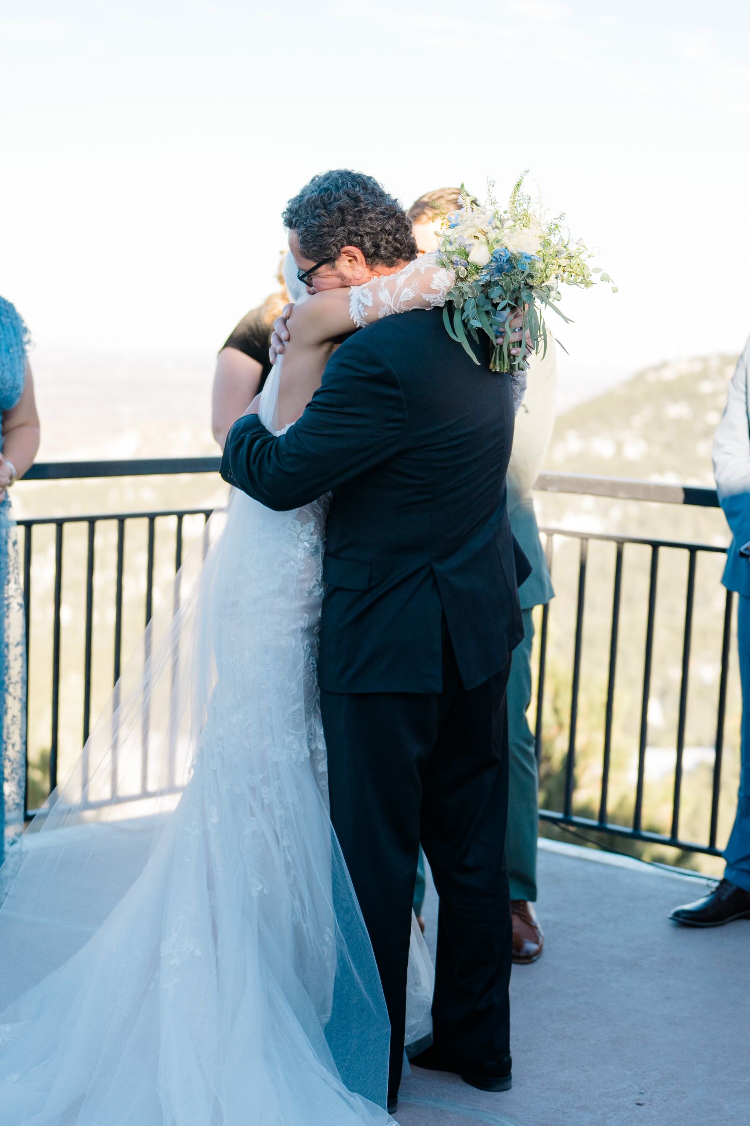 bride and dad hugging on wedding day