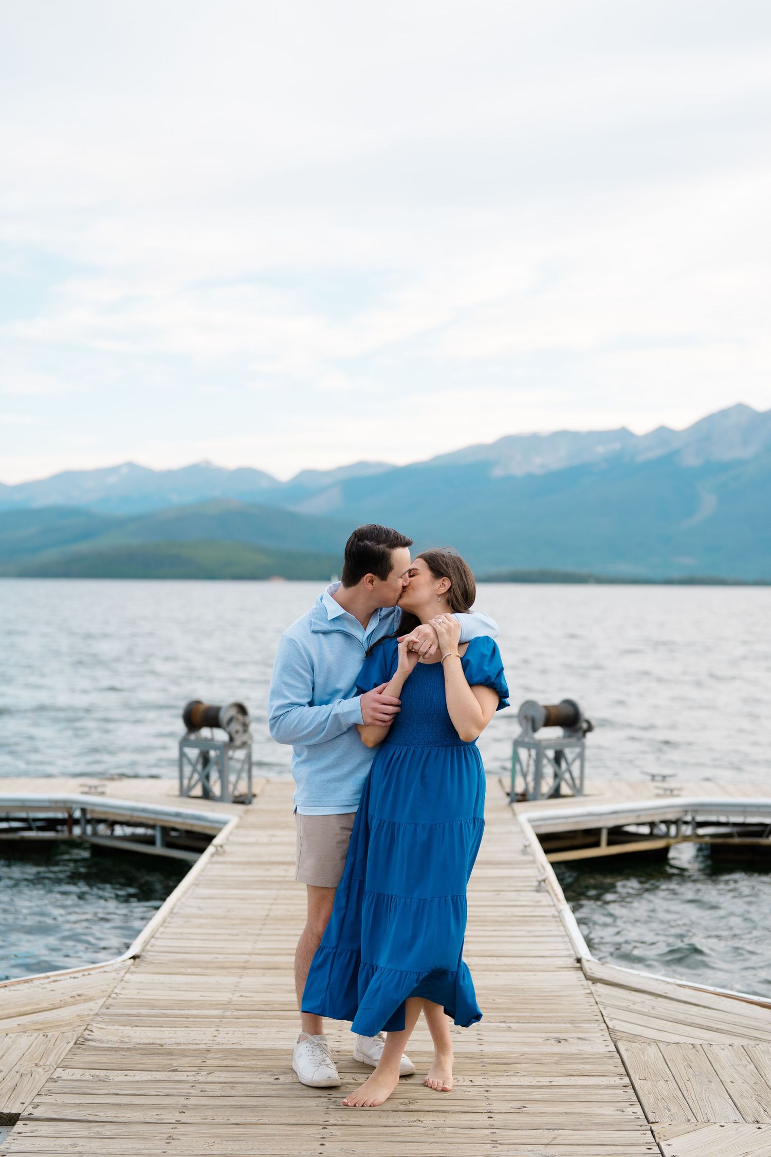 guy and girl kissing on a boat deck after getting engaged