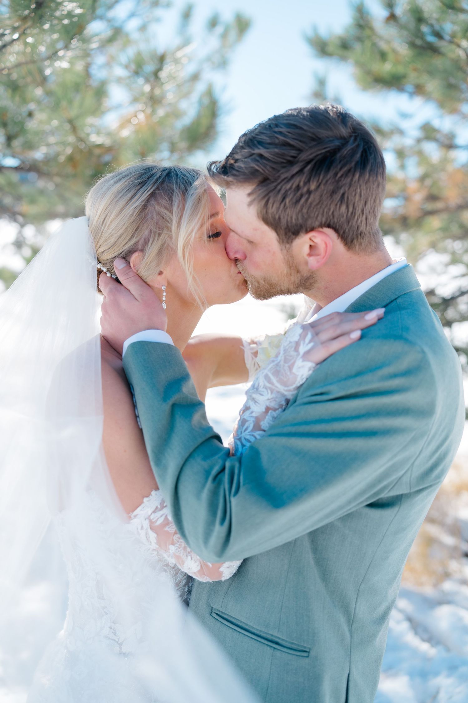 couple kissing and embracing on wedding day