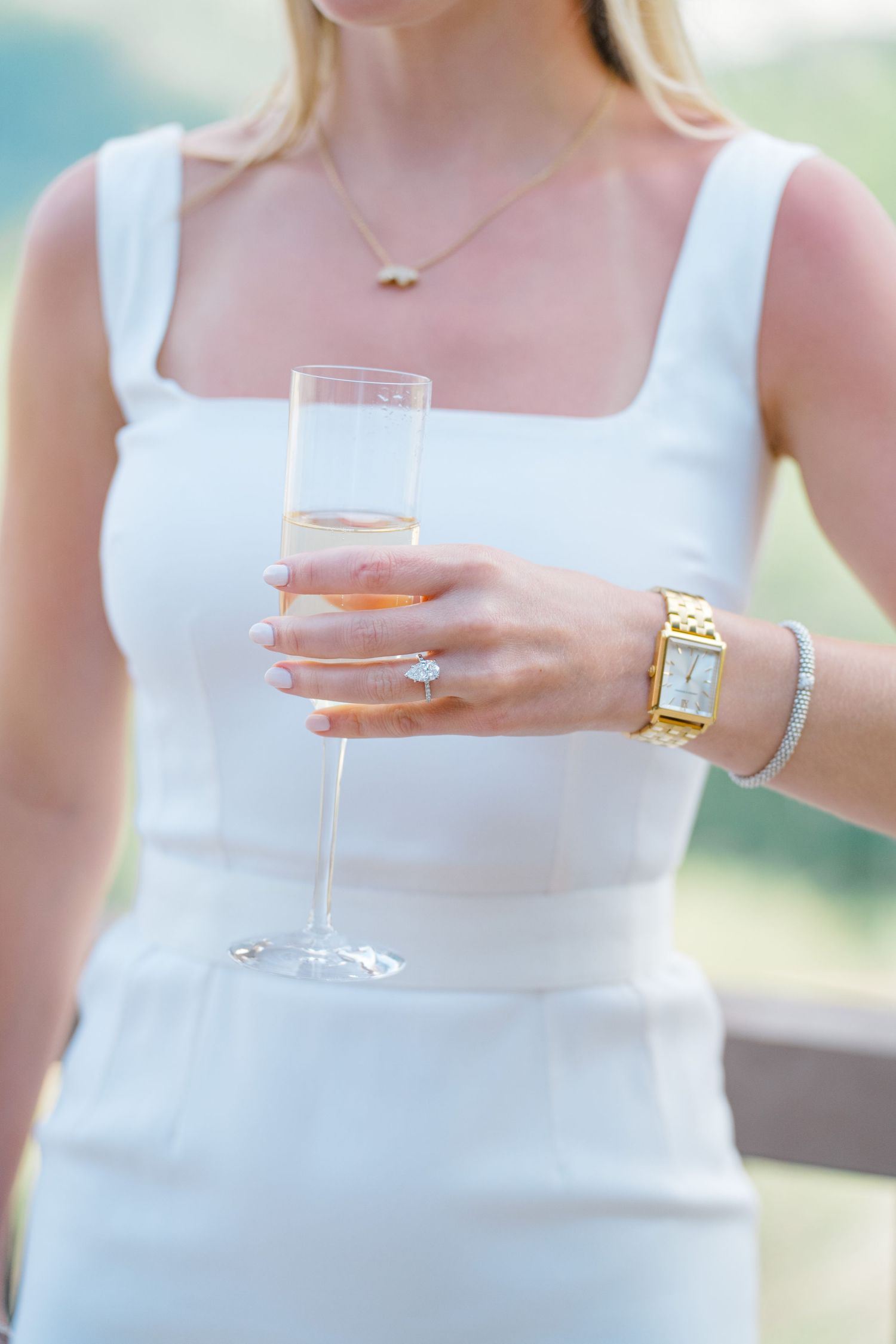 picture of girls body with vail necklace and engagement ring