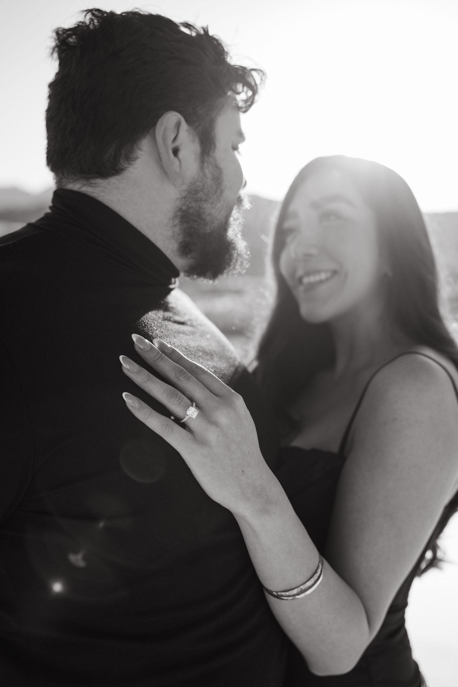 A romantic black and white photo sequence showing an intimate couple embracing in soft natural light.