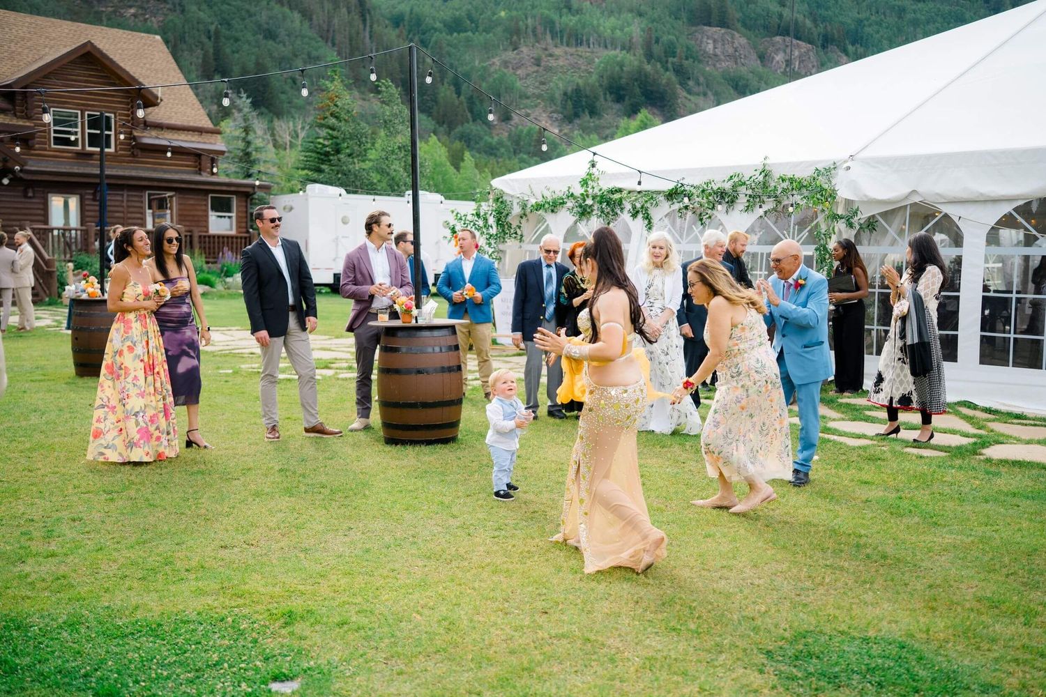 Camp Hale Outdoor wedding reception setup with white tents and rustic decor against a mountainous backdrop.