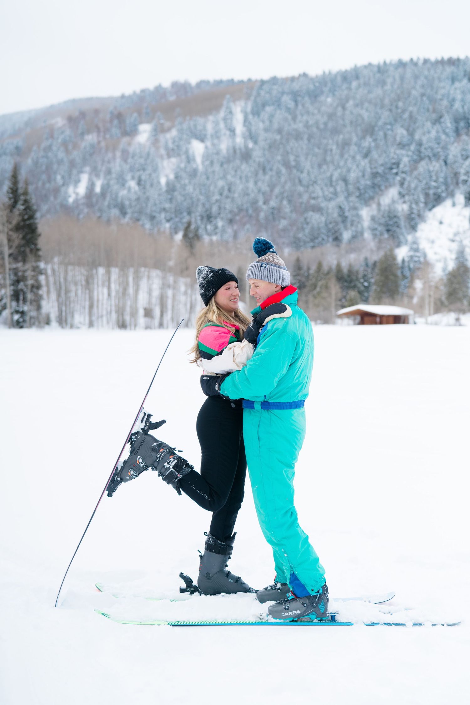guy and girl smiling at each other with foot popped with ski on it