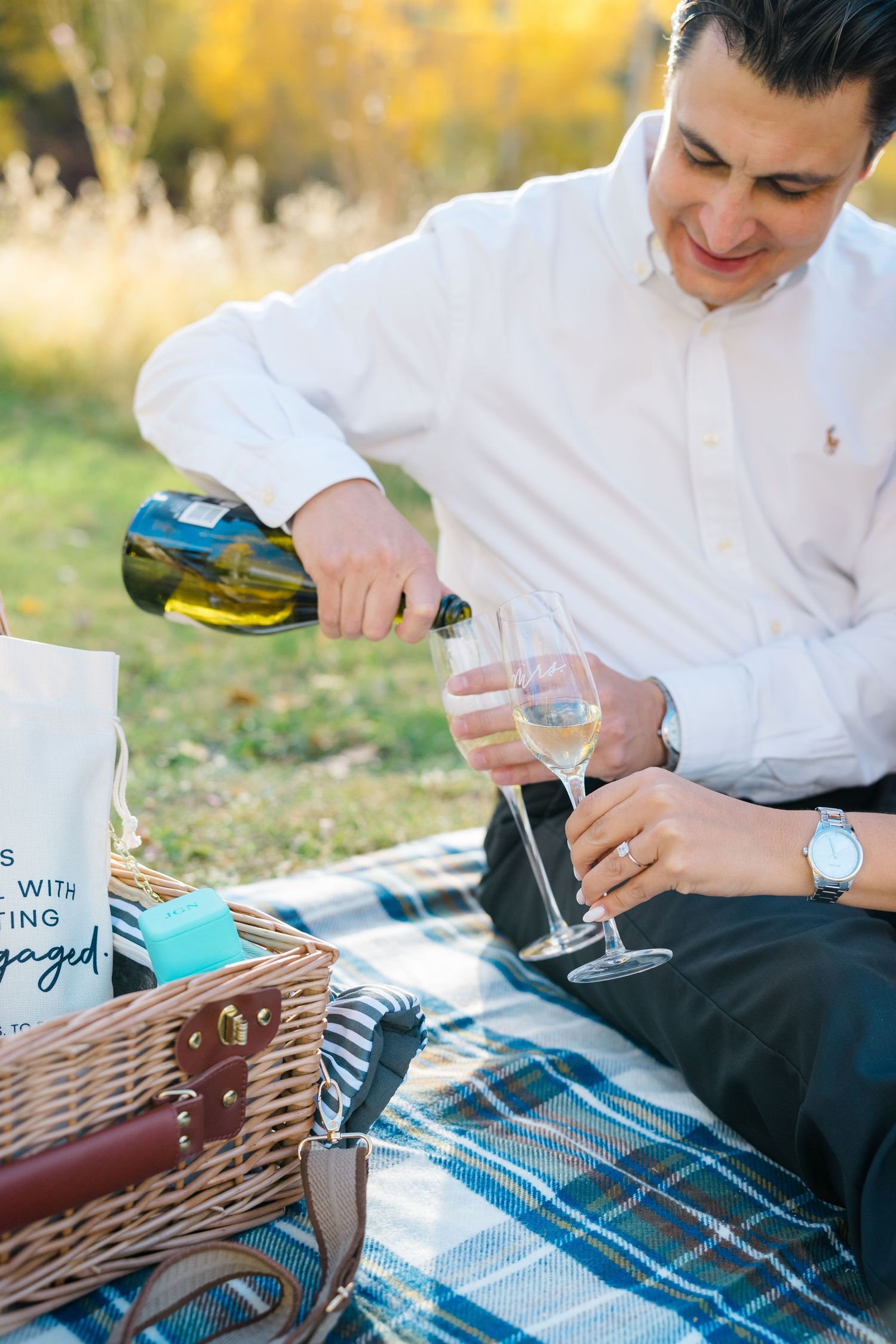 A series of photos showing someone pouring drinks on a picnic blanket with a wooden chess or backgammon board.