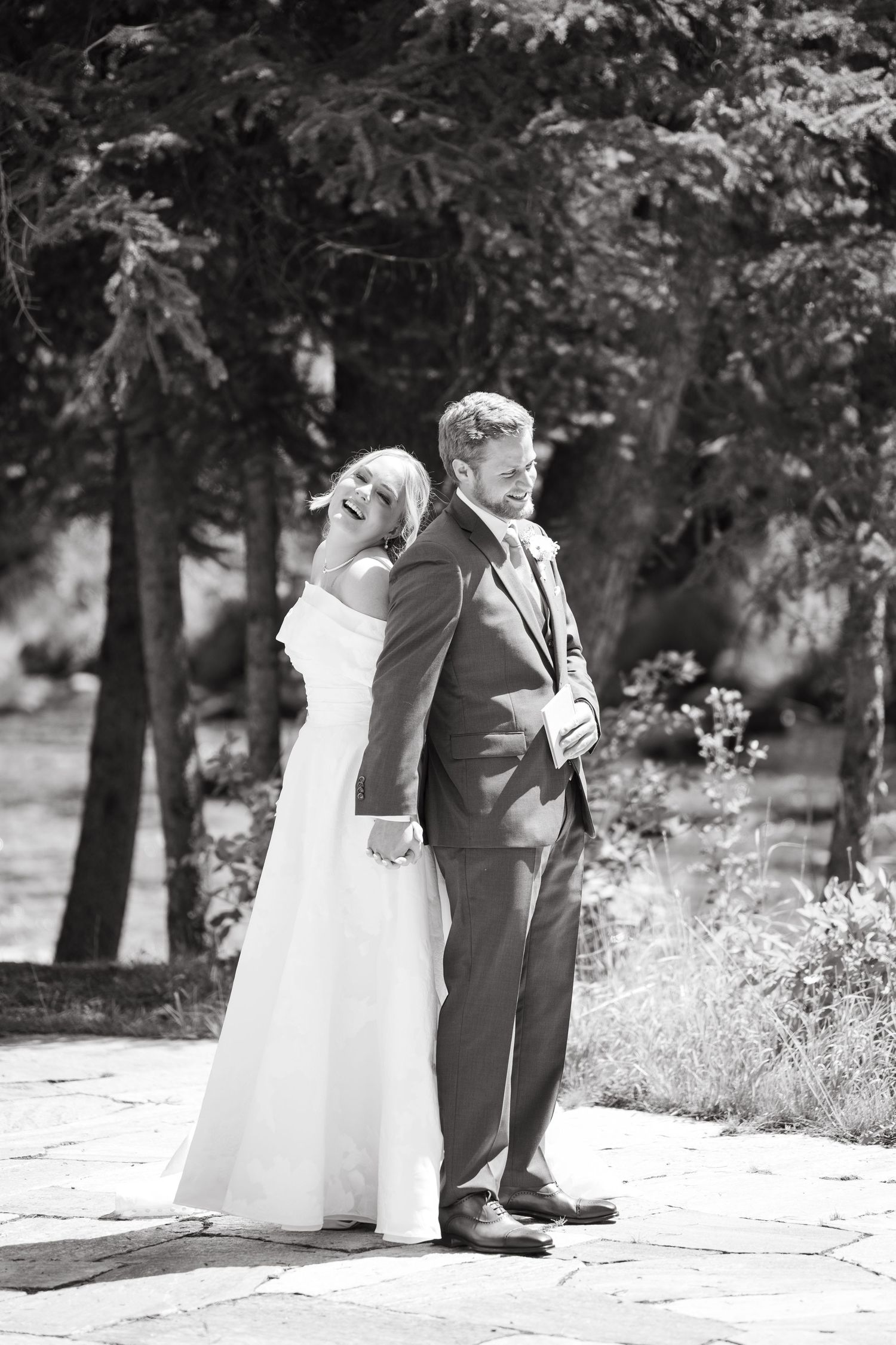 A series of black and white wedding photos showing close-up details of a bride and groom's feet and formal attire.