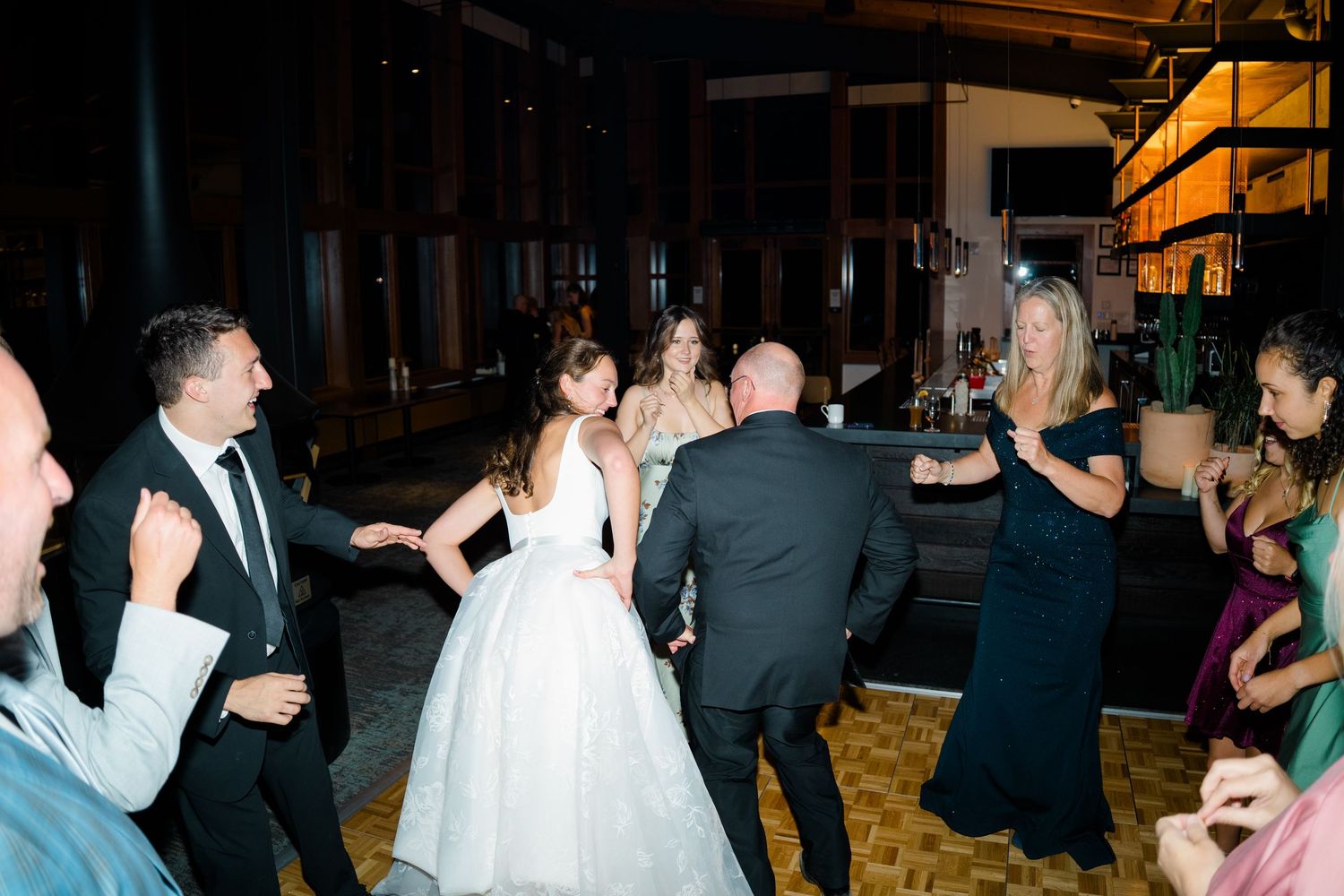 Wedding guests dancing and celebrating on a crowded dance floor during an evening reception at aerie copper mountain.