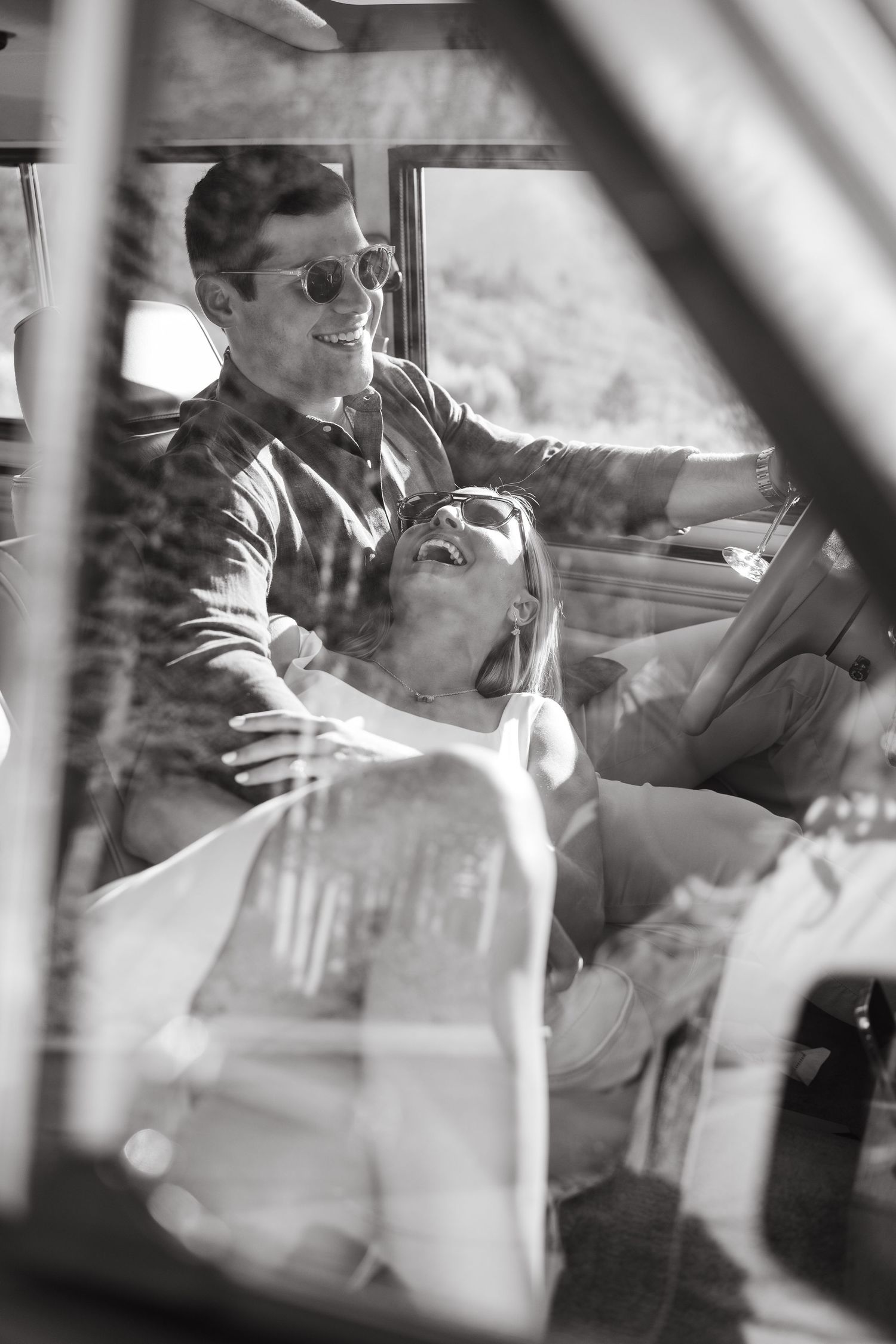 guy and girl smiling as they cuddle in the car after getting engaged