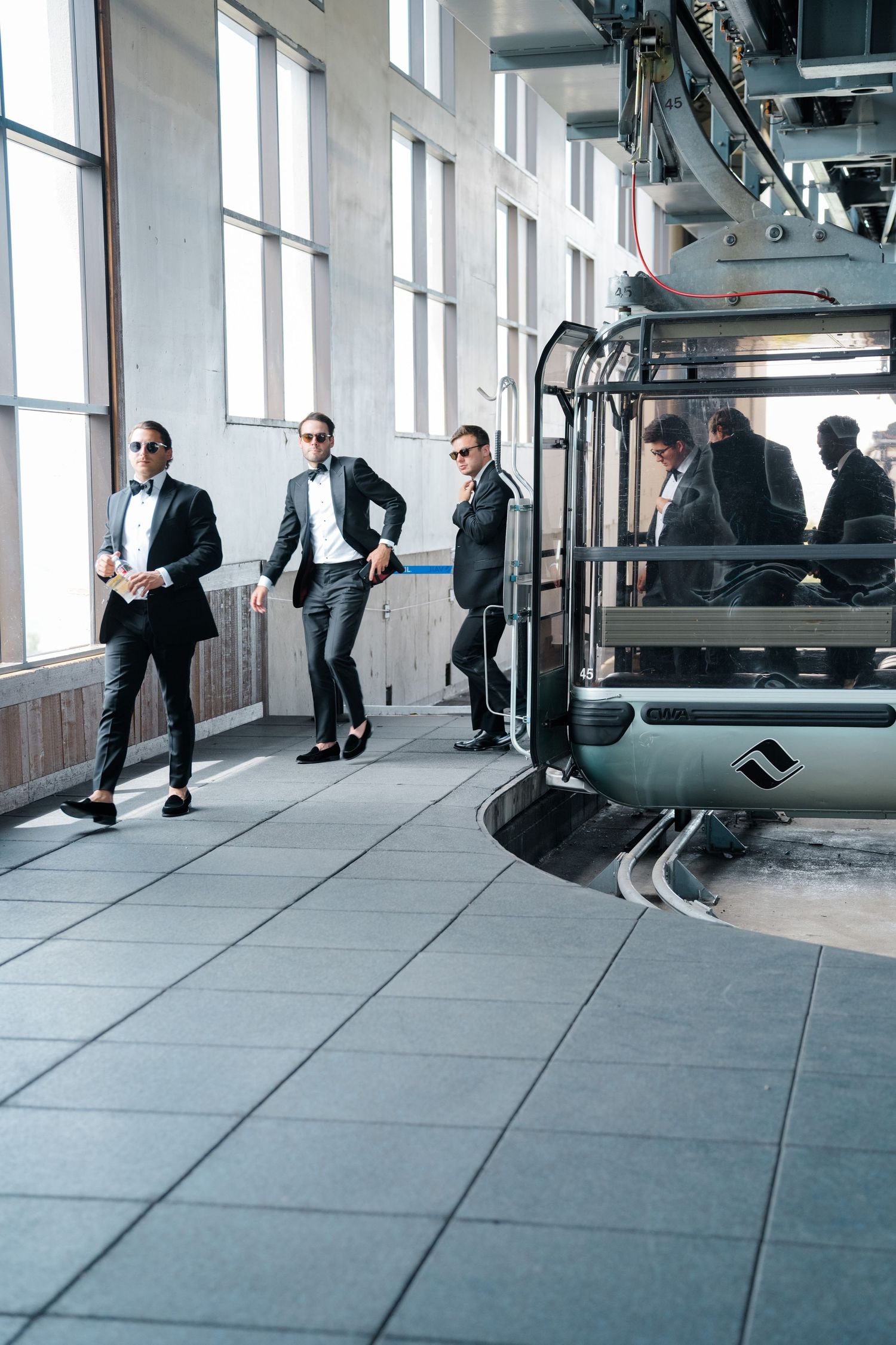 Business people walking through a modern office hallway shown in multiple sequential frames at vail wedding getting off gondola.