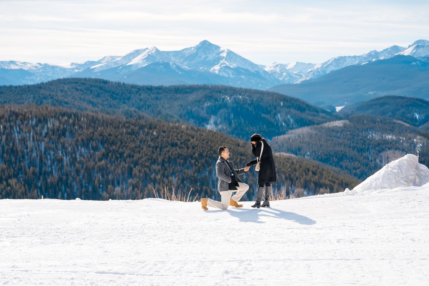A snowy mountain landscape with ski tracks and winter sports enthusiasts enjoying outdoor recreation activities.