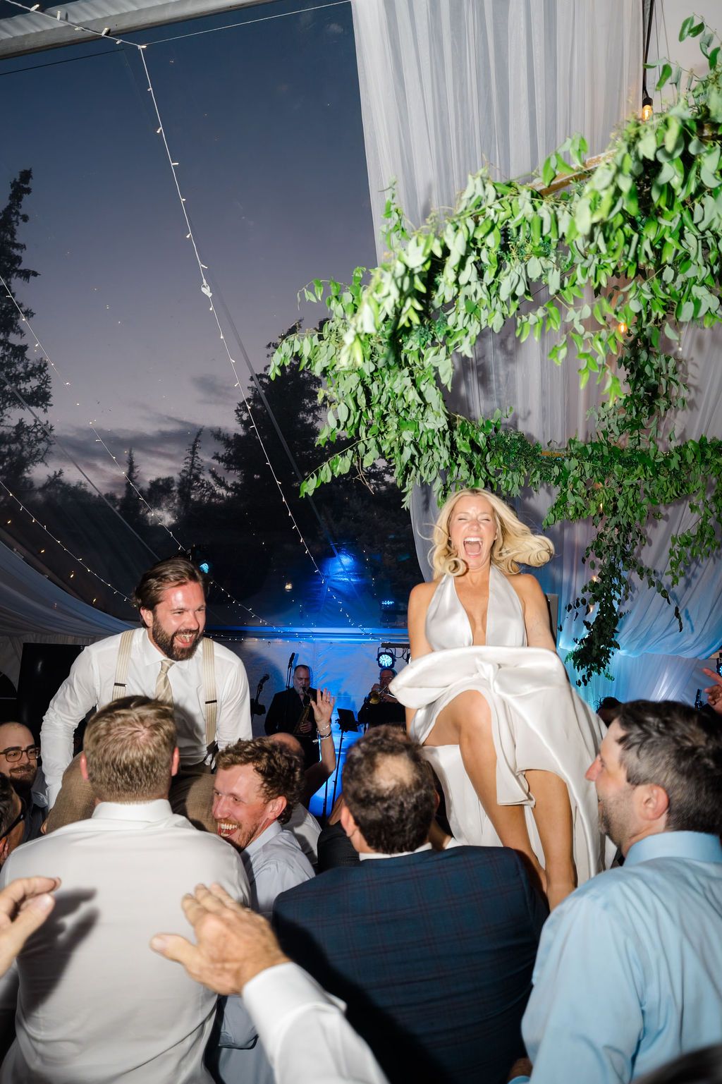 Bride and groom lifted by guests during joyful hora dance at their Grand Hyatt Vail wedding