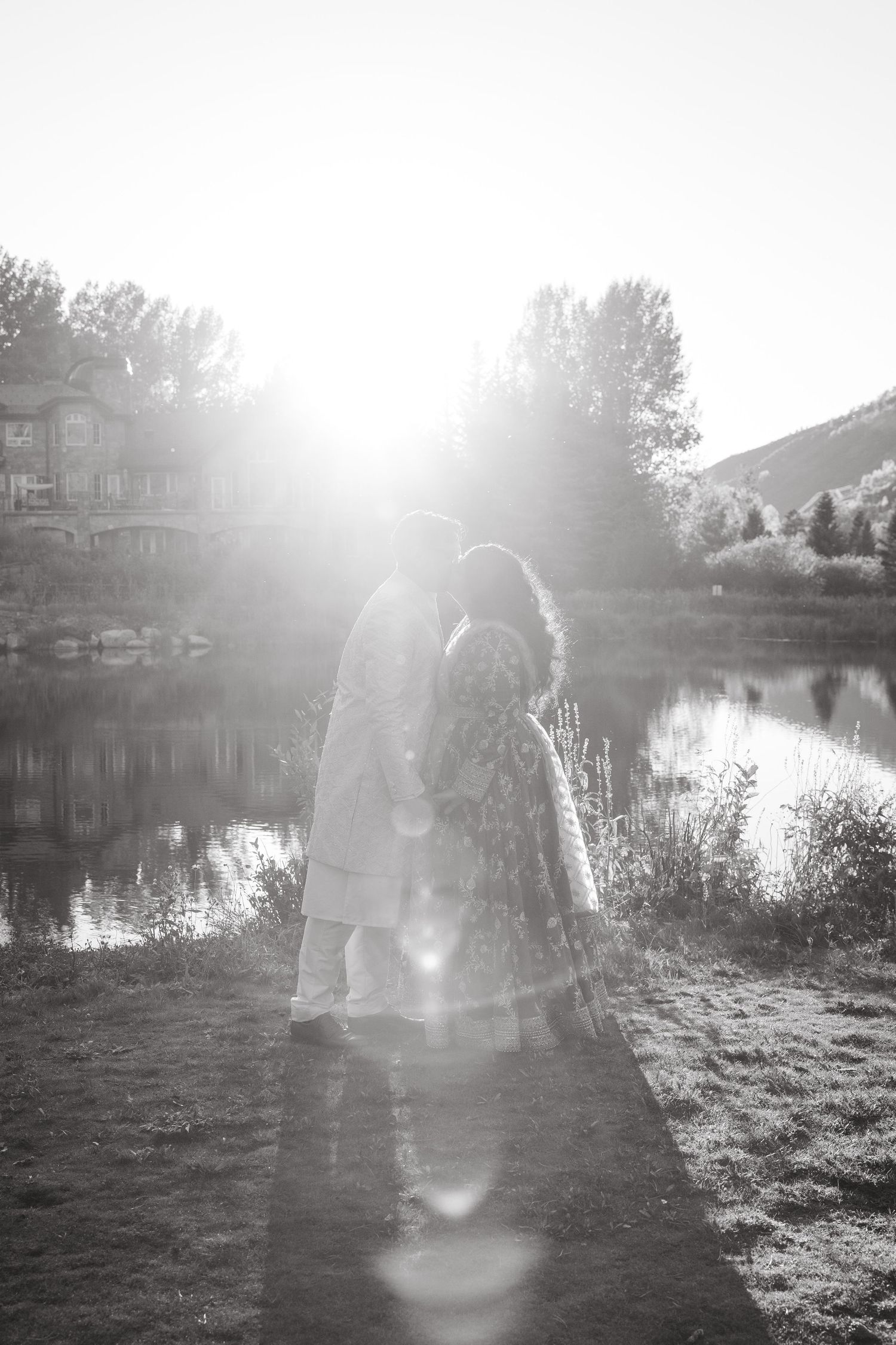 Dreamy black and white landscape photos with sunlight flares creating ethereal effects over a lakeside setting.