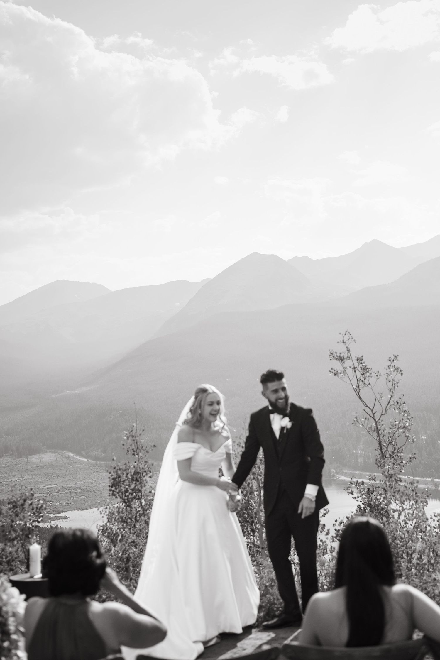 Wedding ceremony silhouettes against a dramatic mountain backdrop with cloudy skies taken by Breckenridge Wedding Photographer.