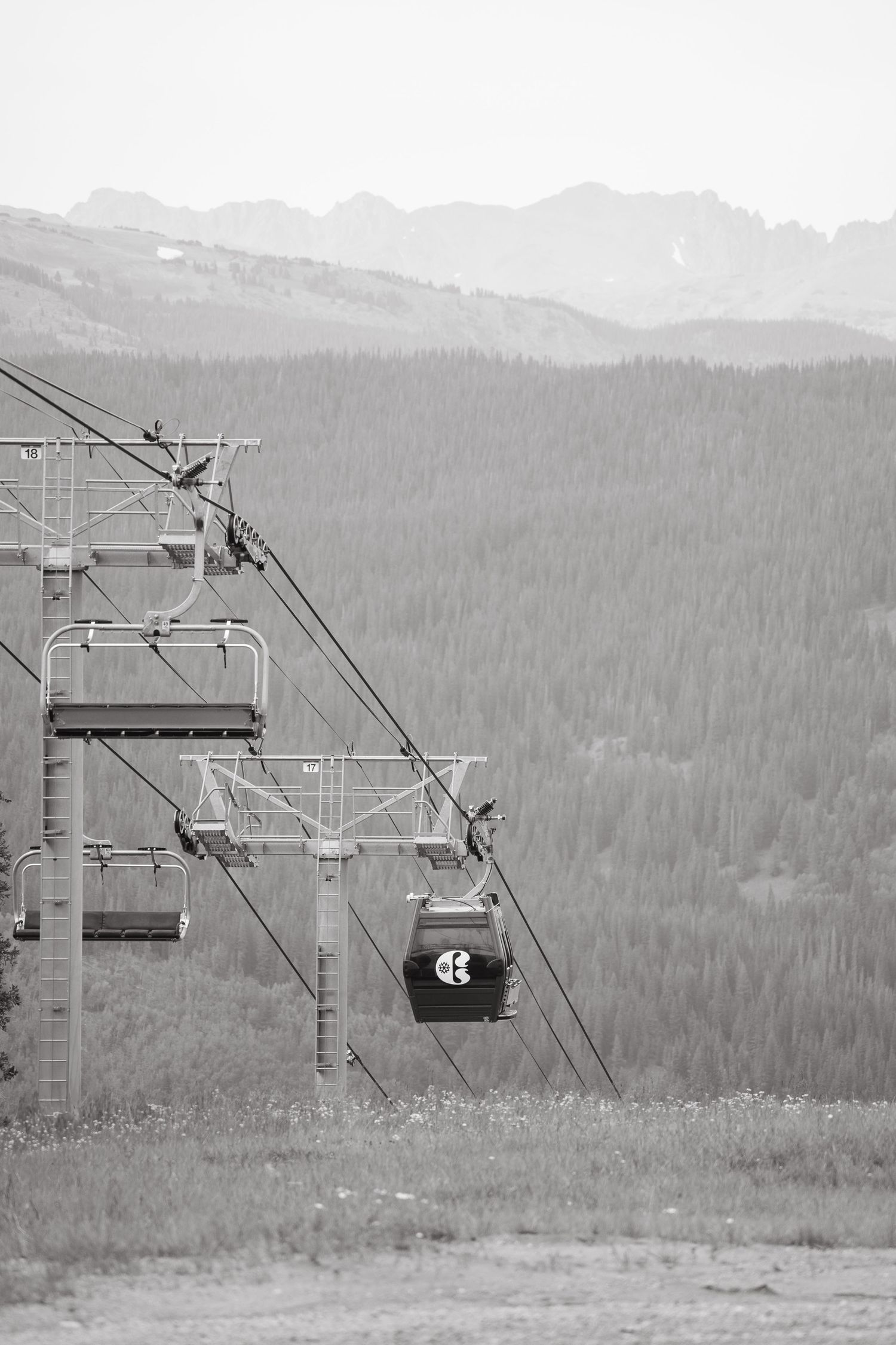 Black and white photos show ski lift chairs ascending mountain slopes at copper mountain against a forested alpine landscape backdrop.