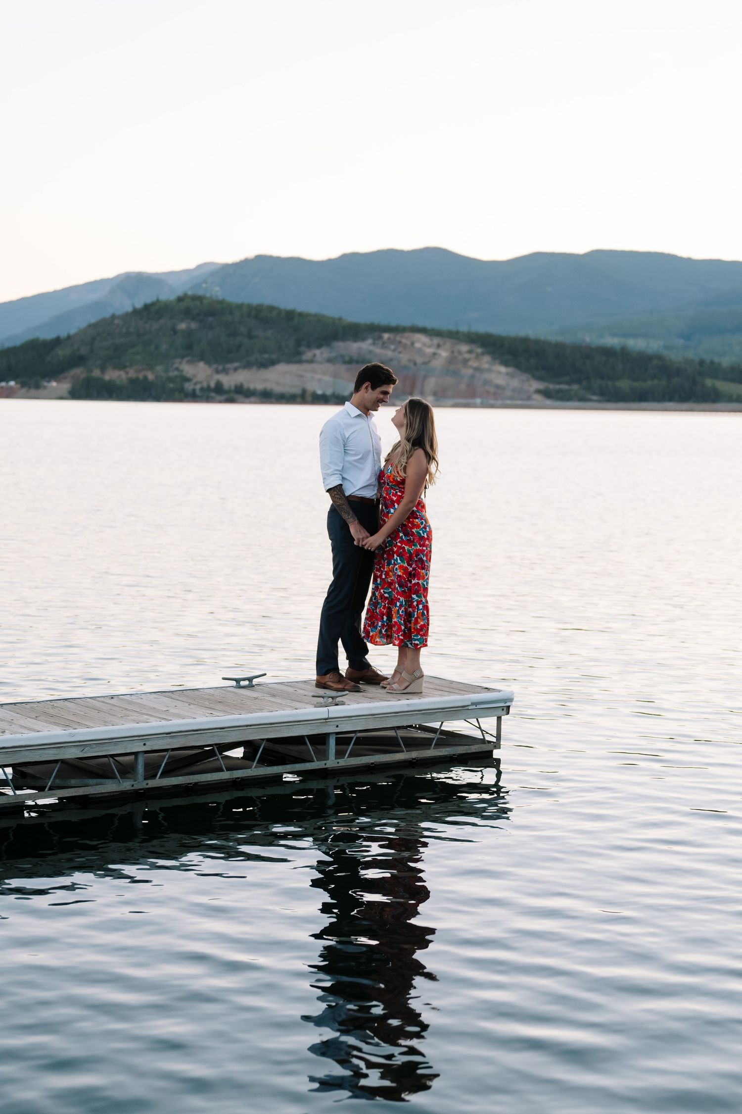 guy and girl standing on dock