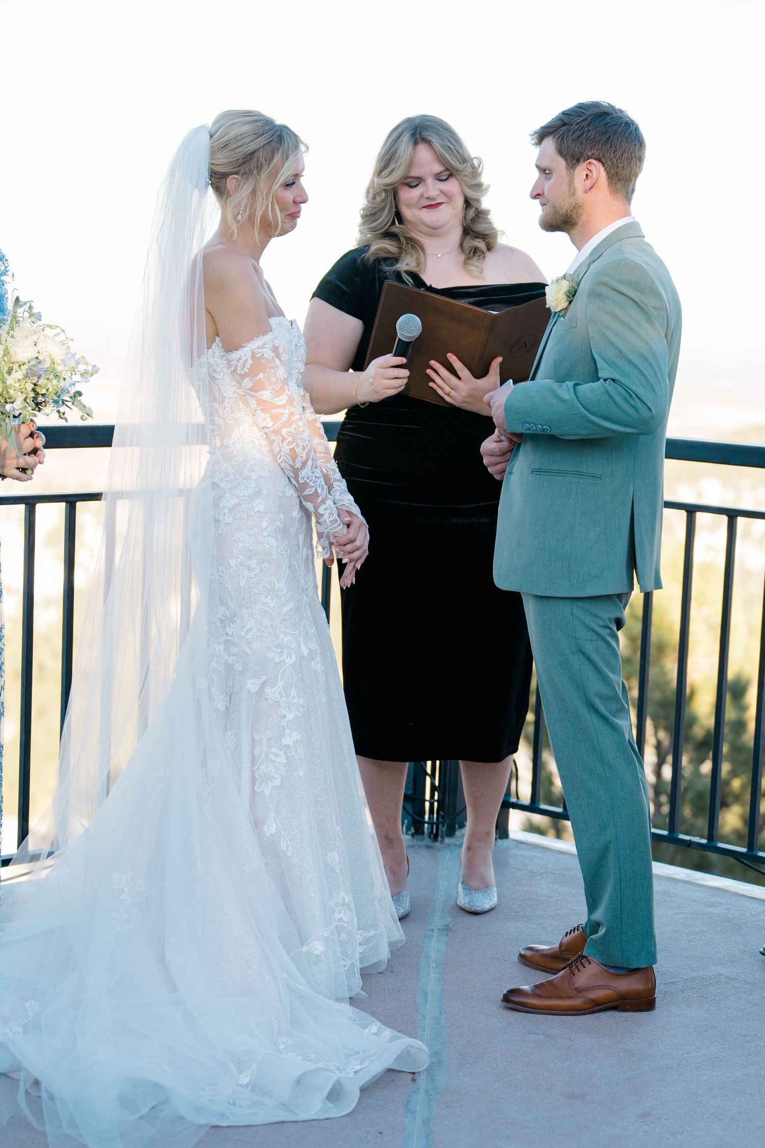 couple gets married in front of mountains on deck