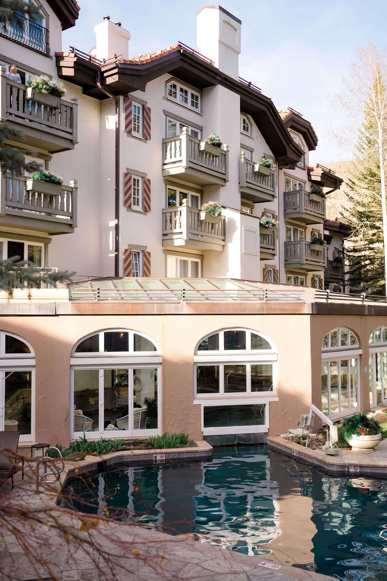 Sonnenalp Luxury alpine hotel with balconies and outdoor pool, featuring European architecture in a mountain resort setting.