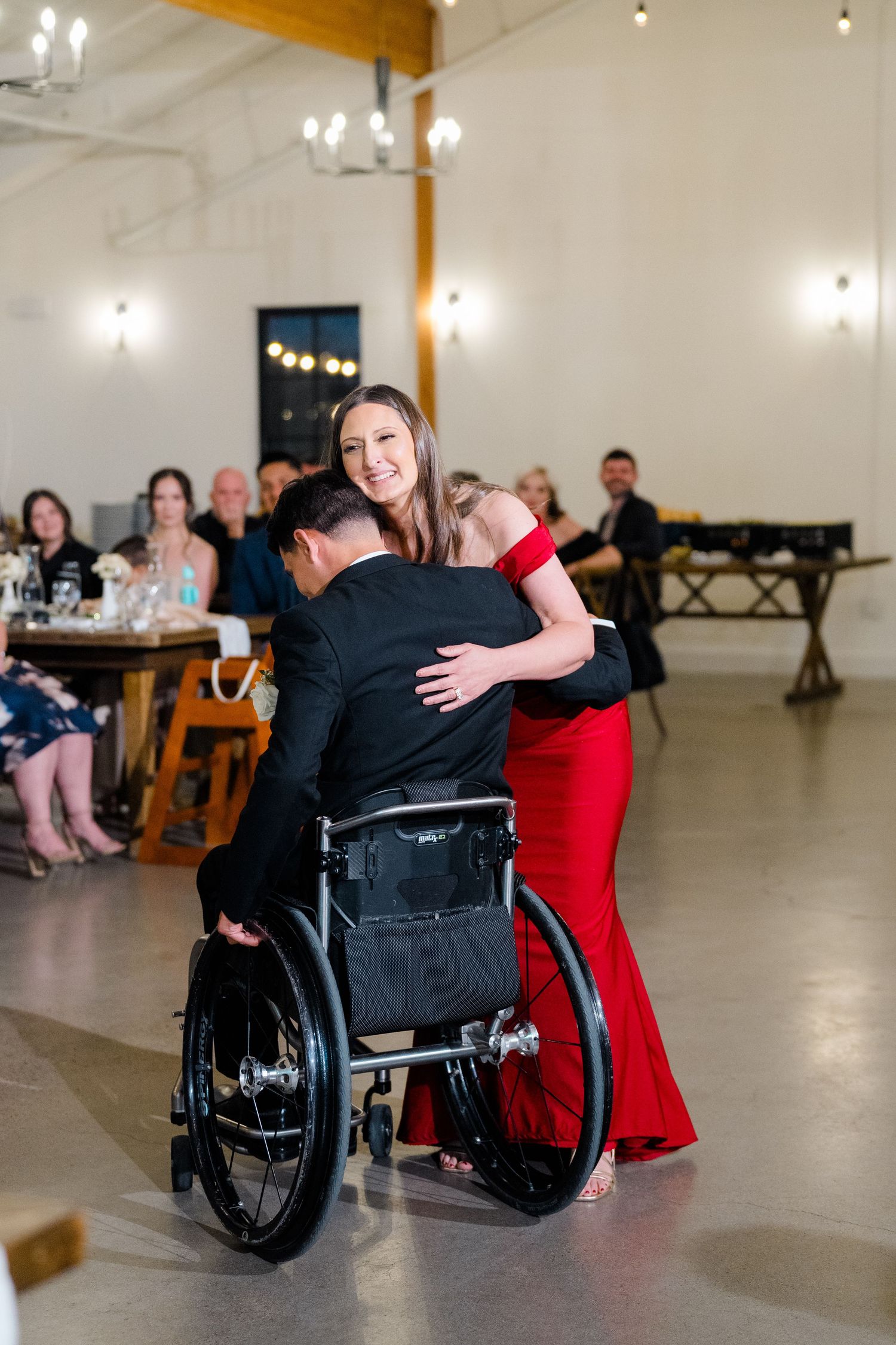 Neven Hart shares a dance with a guest at the wedding reception at Canopy Grove in Escondido, California, photographed by Sierra Sturt Photo