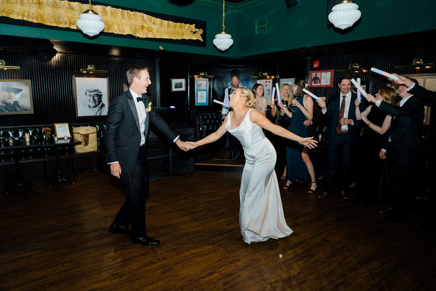 Wedding reception dance floor with guests celebrating under paper lanterns.