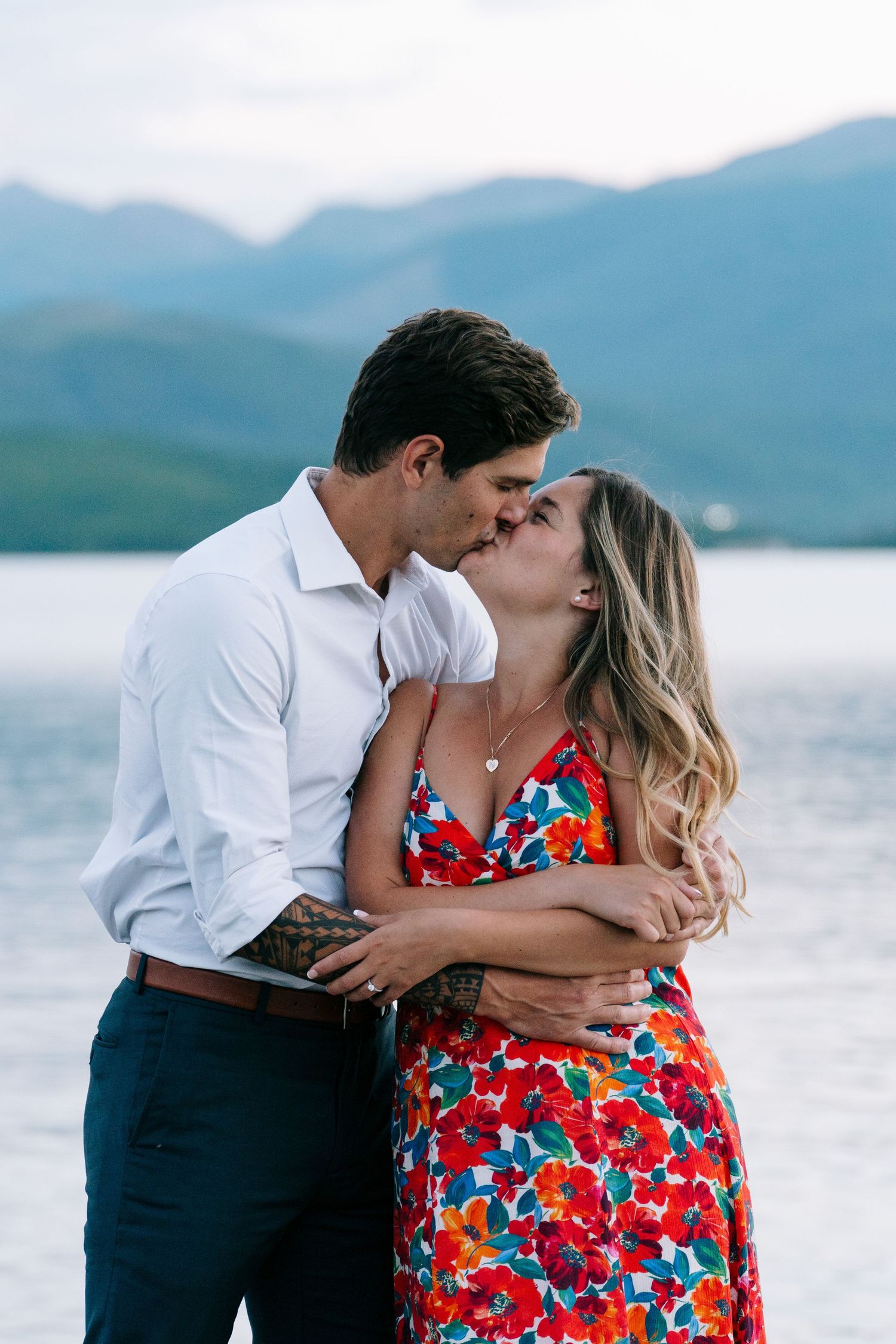 guy and girl kissing on the water