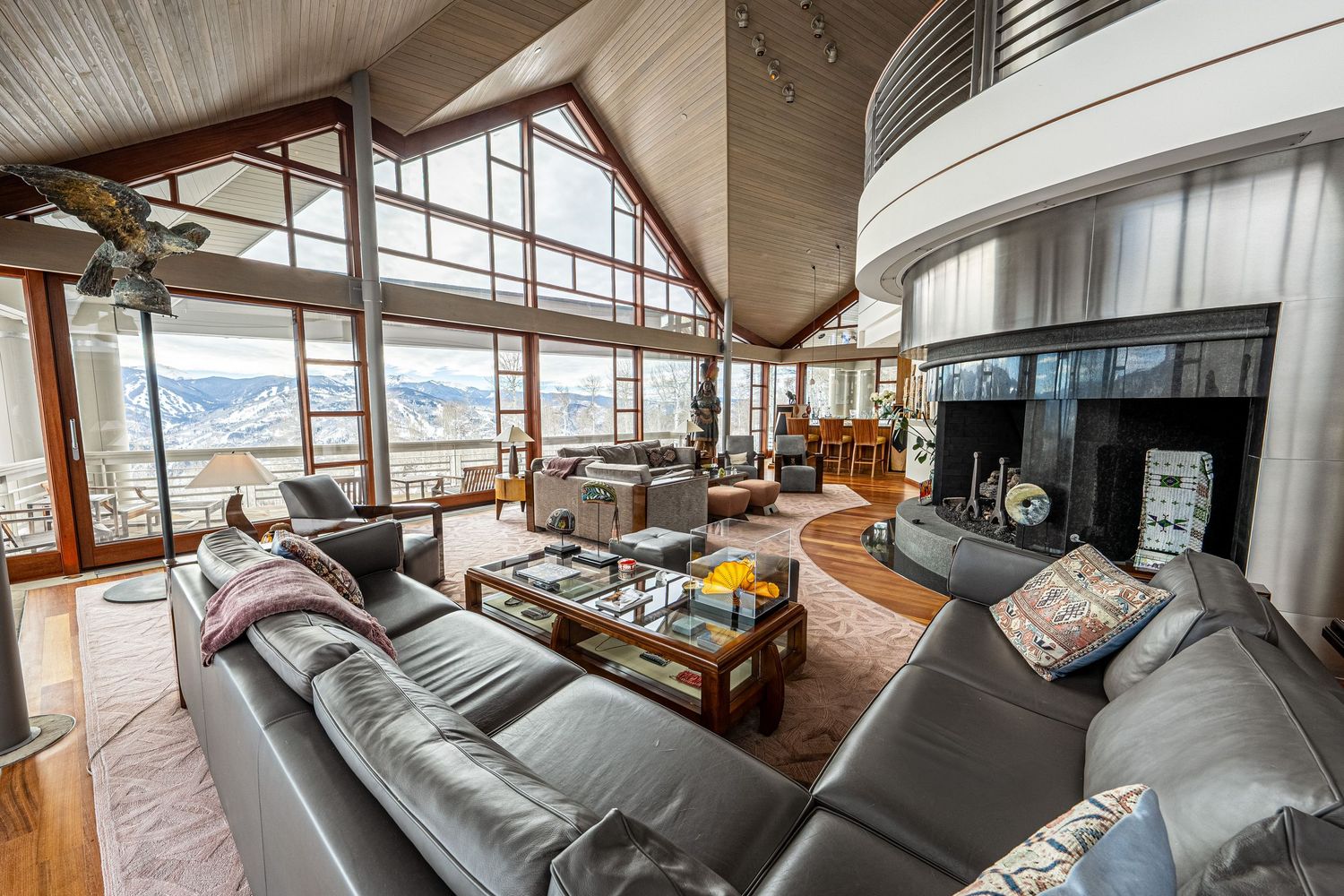 Spacious living area with floor-to-ceiling windows overlooking mountain landscape.