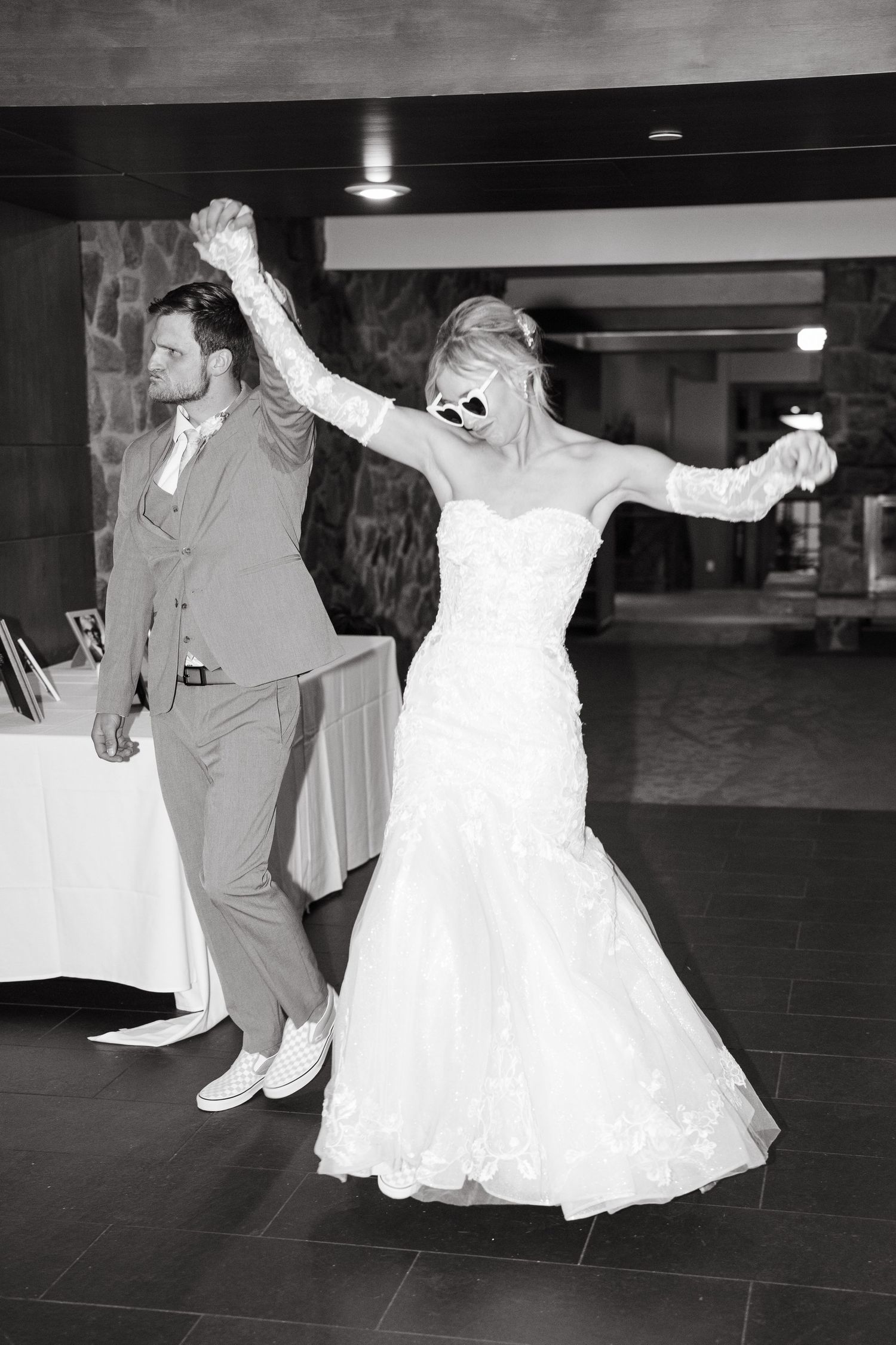 black and white photo of couple celebrating at wedding reception