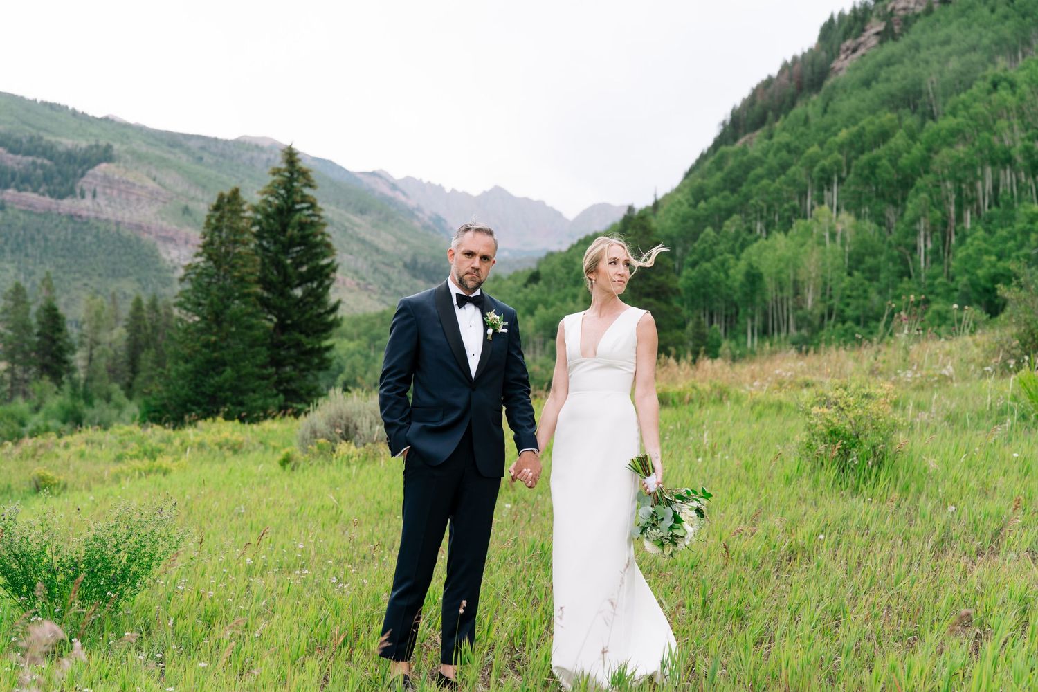 bride and groom posing in vail colorado on wedding day
