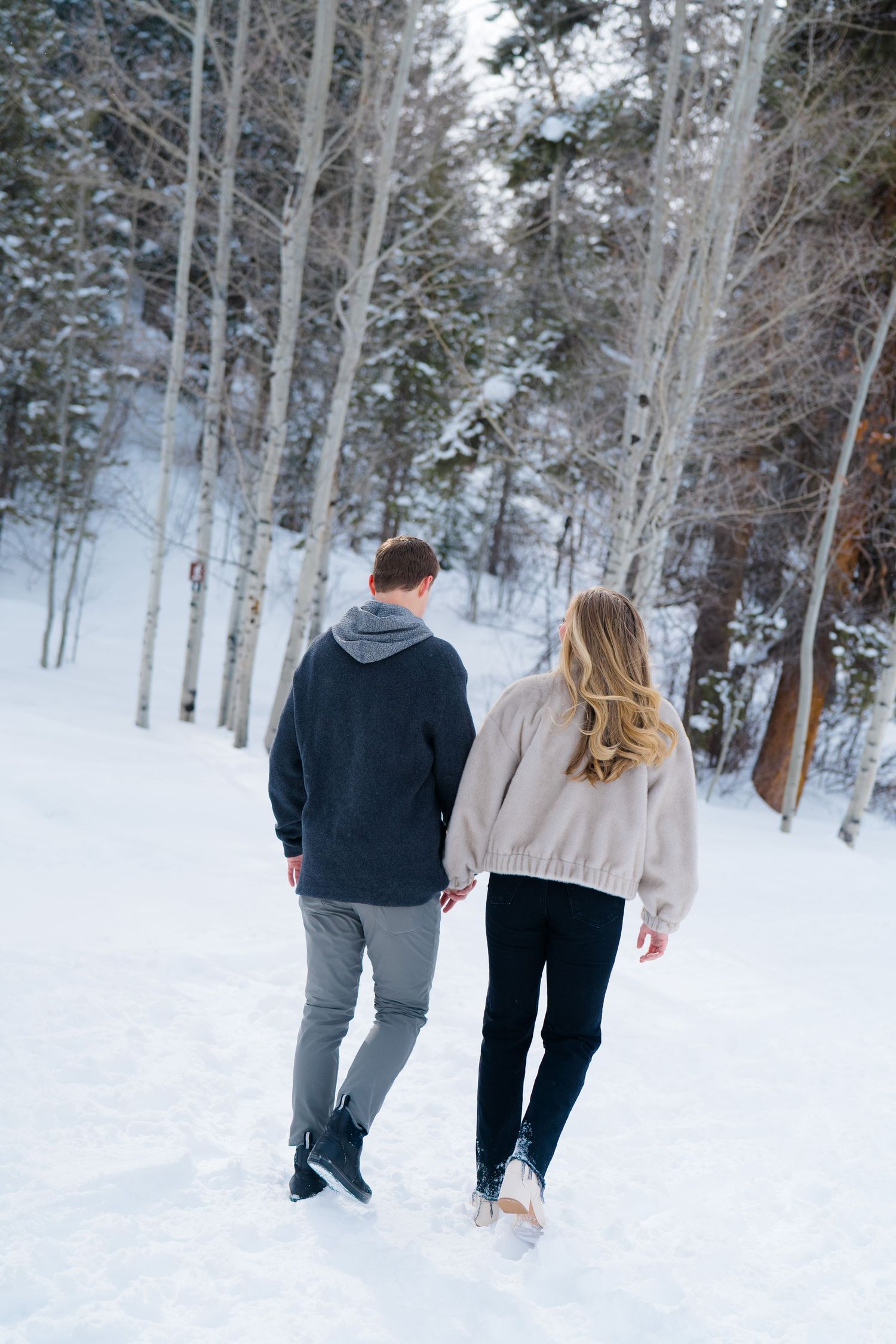 guy and girl walking away from camera
