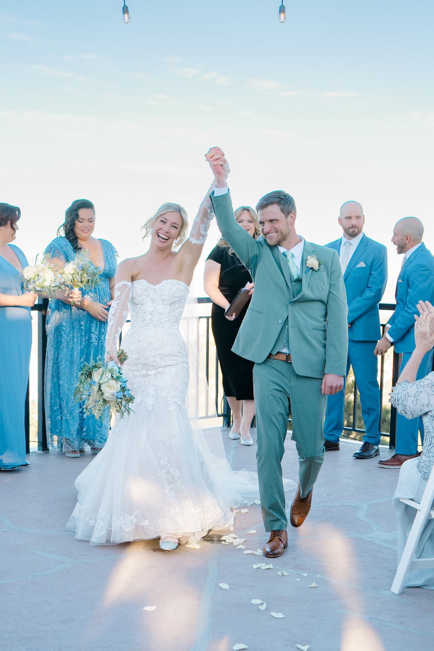 couple walks down the aisle celebrating