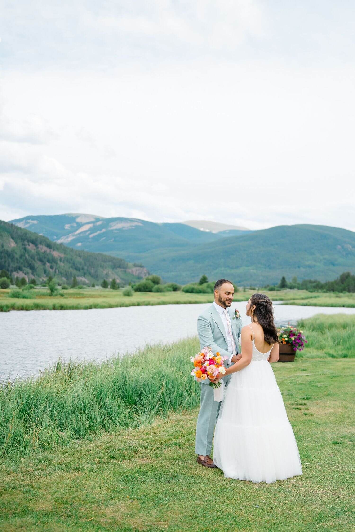 Camp Hale romantic wedding photoshoot in a scenic mountain landscape with a lake backdrop.