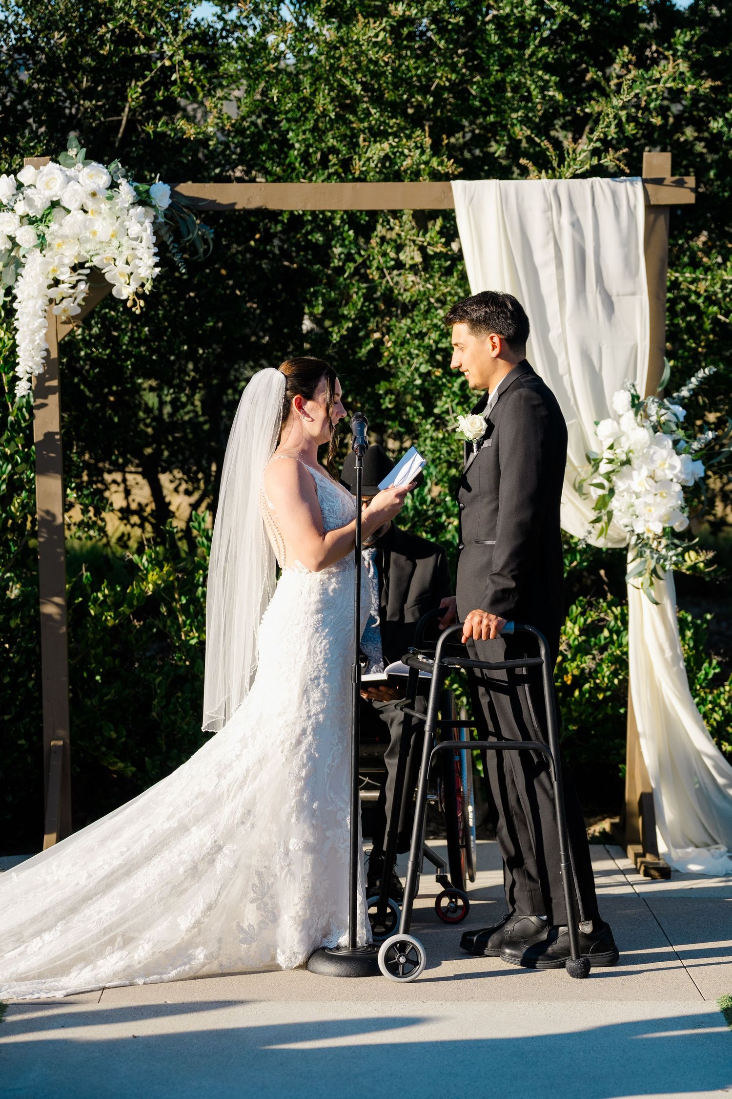 Amber Hart reads her vows to Neven Hart at their outdoor ceremony at Canopy Grove in Escondido, California, photographed by Sierra Sturt Pho