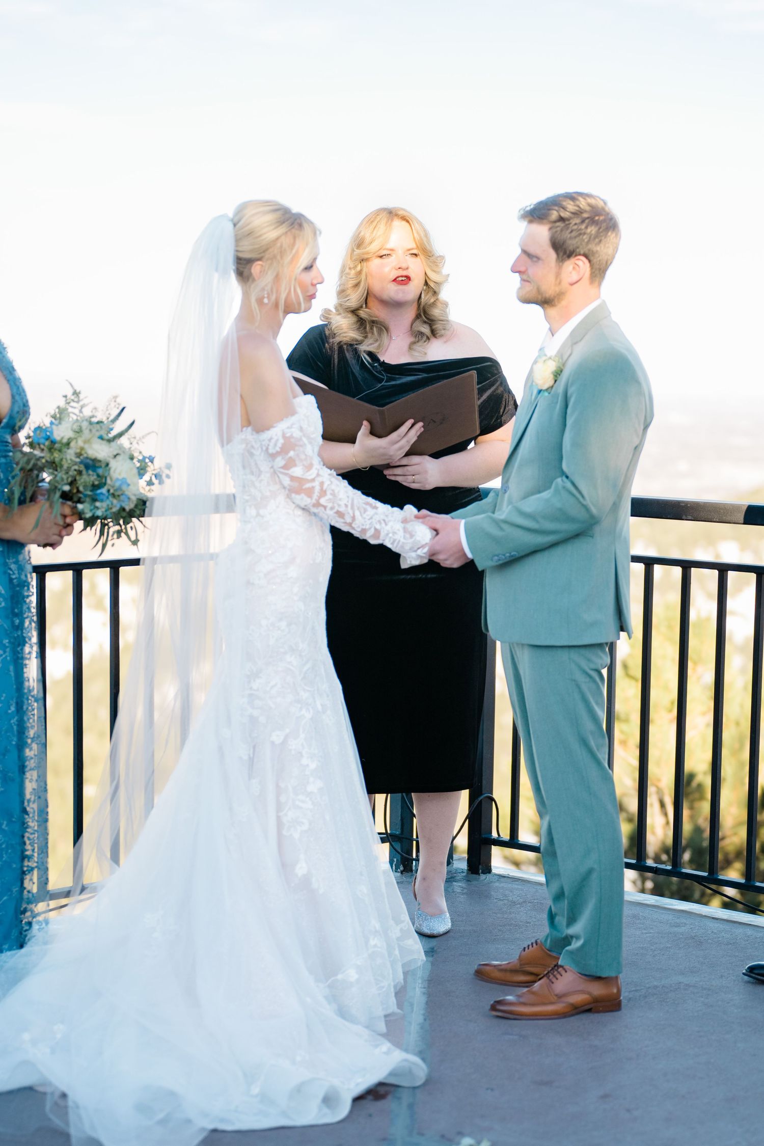 bride and groom getting married holding hands during ceremony
