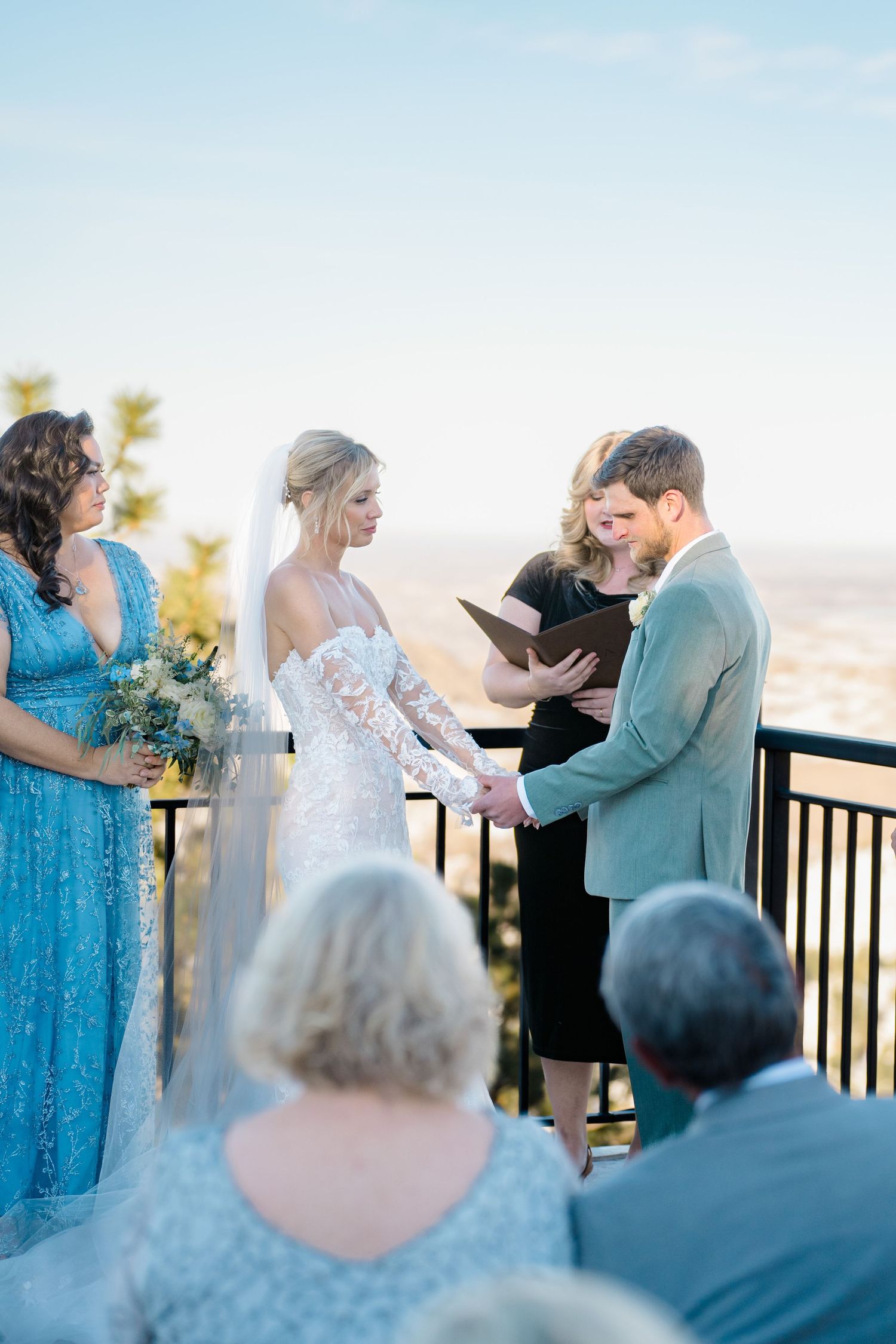 bride and groom getting married holding hands during ceremony
